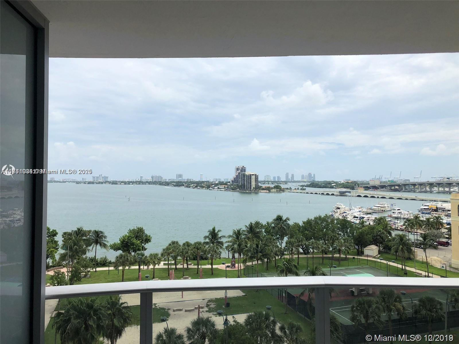 Embrace the essence of waterfront living at Arian on the Bay. This exceptional residence offers stunning bay views, a cozy den converted to a bedroom, sleek Italian tile floors, and a contemporary kitchen with modern appliances. Step onto the spacious balcony to enjoy breathtaking sunrises and gentle bay breezes. Residents enjoy a curated collection of amenities, while same-floor parking adds everyday ease. This is your retreat in the heart of the bay.