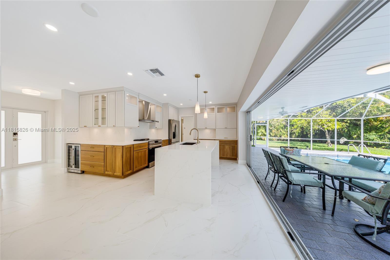 Completely remodeled with love and attention to every detail, this home is absolutely sparkling and ready for its new residents! Enjoy the bright kitchen/ dining/family area that can be completely open to your  beautiful pool and garden, tastefully protected from falling leaves and mosquitos. Amazing porcelaine floors throughout, 4 spacious and light filled bedrooms, 2 modern bathrooms, each with access to the pool. Property features a garage and plenty of additional parking outside, hurricane proof windows, brand new appliances, including a wine cooler, extensive lighting. Exceptional quality for an unbeatable price.