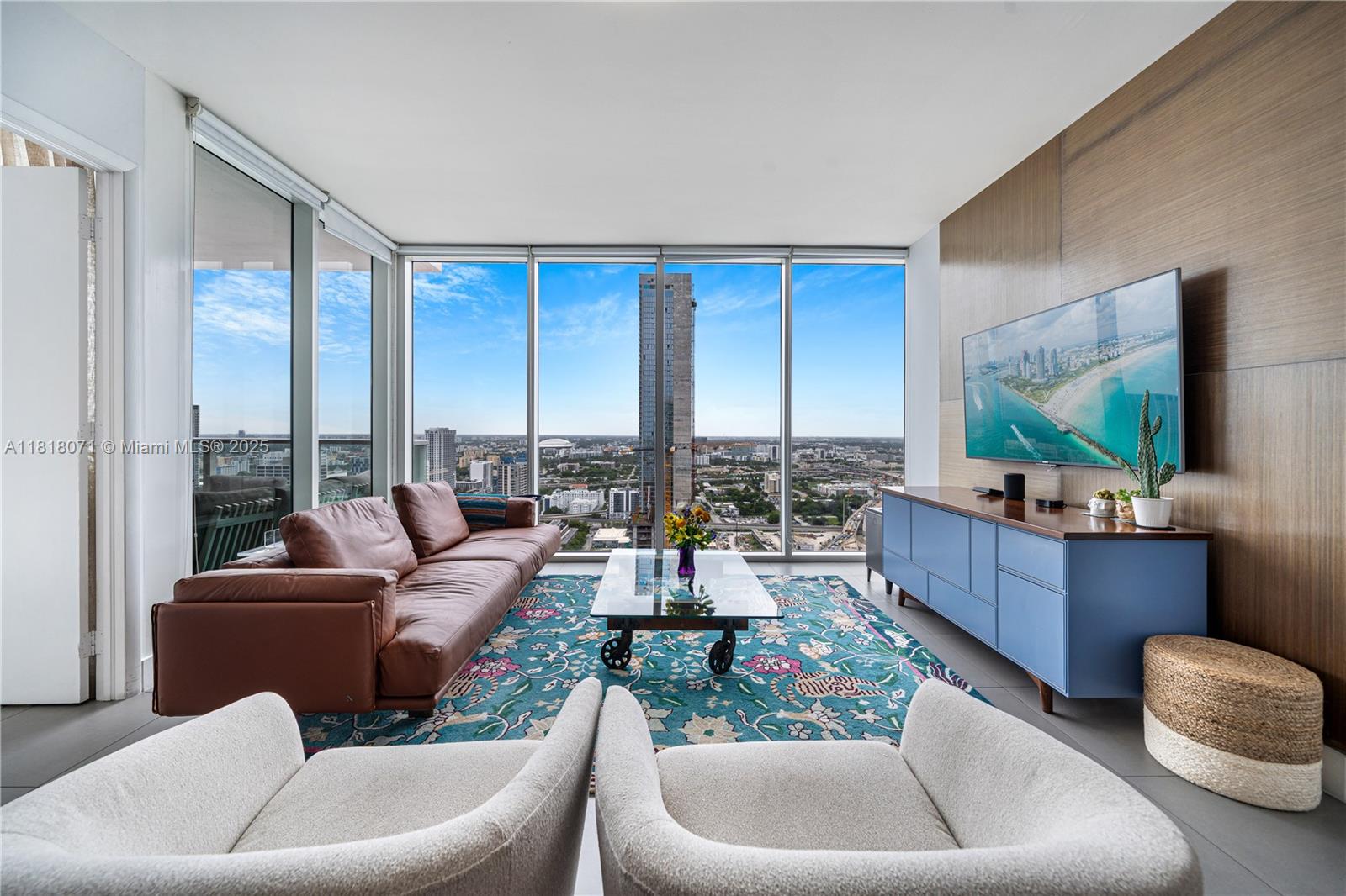 Experience elevated living from this coveted 36th-floor 07-line residence at Ten Museum Park, where dramatic sunset and skyline views create a stunning backdrop to the ultimate lifestyle. This 2-bedroom, 2.5-bath, 1,123 SF home features floor-to-ceiling windows, porcelain flooring, and a thoughtfully reimagined primary suite with a spa-inspired shower with Spanish tile, and an oversized walk-in closet. Both bedrooms offer full-wall privacy, creating a true retreat in the sky. Indulge in an unparalleled lifestyle with five dipping pools including a cold plunge, a state-of-the-art gym, the world-renowned Clinique La Prairie Spa, and exclusive beach club membership in the trendy South of Fifth neighborhood. A rare opportunity to own a sophisticated urban sanctuary in the heart of Miami.
