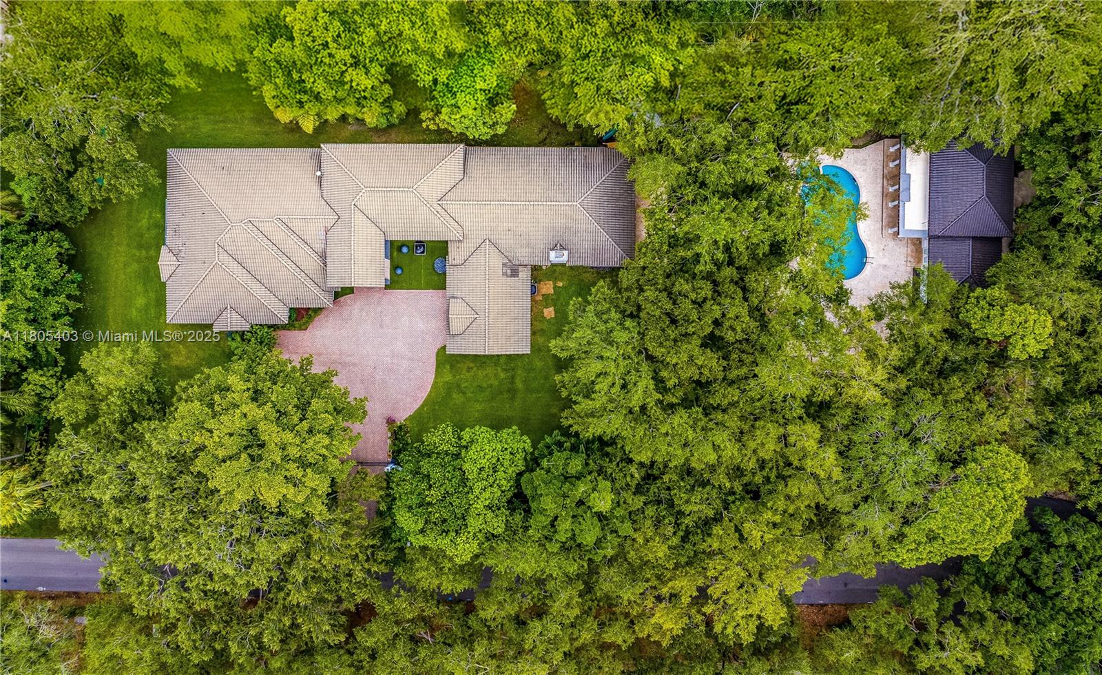 Stunning gated 1-story 8,126 total SF residence on a quiet cul-de-sac in prime North Pinecrest, steps from Gulliver & Beth Am. Set on a lush 1.1 acre with a 2-story, 1,300 SF guesthouse, treehouse, & ample parking. The 6-bed, 5.5-bath main home offers an office, new impact windows/doors, & Firenze Carrara polished marble tile throughout. Gourmet kitchen boasts a leather-textured marble island, Veneta Cucine cabinetry, & Miele appliances. Guest bath features full-height, single-slab Italian tile. Primary suite includes dual walk-in closets & a spa-style bath with Kohler DTV+ faucet less system for steam, audio, chromotherapy, & lighting. Whole-house Brilliant system manages lighting, Zoom intercom, & Sonos audio indoors/out. Outdoor oasis includes a new summer kitchen & resort-style pool.