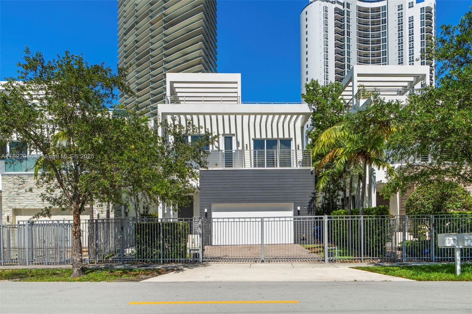Rare opportunity to own ONE of only 15 exclusive townhomes enclaved in the heart of Sunny isles. This 2-story 5BD/4.5BA residence offers refined modern 3,156 sqft of living area with sleek finishes, warm wood floors, and striking architectural details. Sitting on a 4,402 sqft lot, this home includes a pool, a serene patio area, built-in gas BBQ, and an expansive 1,400 sqft rooftop terrace with sweeping ocean views. Stunning chef’s kitchen is equipped with Miele and Dacor appliances, custom Italian cabinetry, and the adjoining dining area flows effortlessly into the living room with 11-ft ceilings. Enjoy the privacy of a 2-car covered garage under A/C & a gated drive way for added privacy. Minutes away from the beach, Bal Harbour Shops, & major areas of interest. No HOA/Maintenance fees.