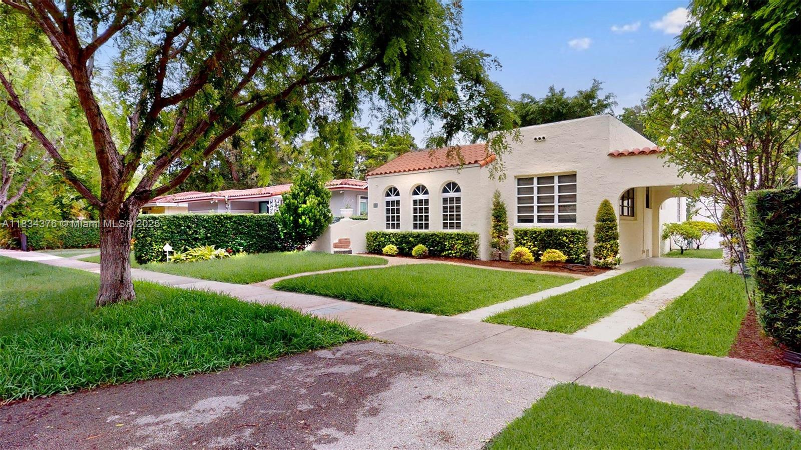 Step into the timeless beauty of this distinguished Old Spanish residence, a true reflection of the architectural charm and sophistication that define 1926 Coral Gables. This inviting home features a graceful layout with seamless transitions between formal living spaces and an elegant kitchen designed for both daily comfort and entertaining. A sunlit foyer sets the tone, leading to expansive living areas adorned with a charming fireplace, original hardwood floors, and soaring, beamed ceilings. Rich in character and history, this exceptional property captures the spirit of classic Coral Gables with its distinctive details and understated elegance a truly a rare opportunity