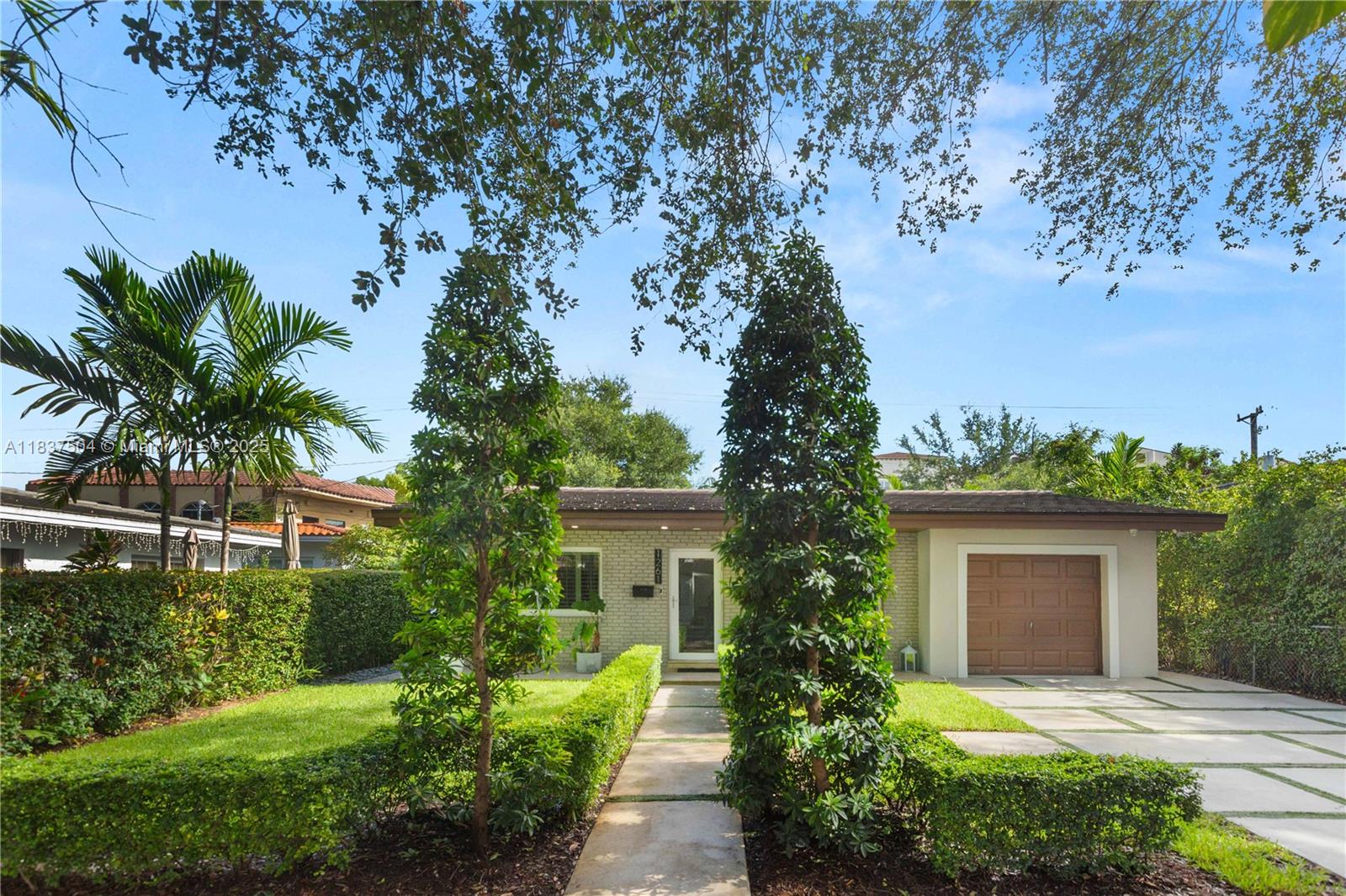 Beautiful and completely turn-key home in the North Gables.  3-bedroom, 2-bath with a one car garage.  This beautiful home sits on a beautiful tree lined street with impeccable curb appeal.  Open plan kitchen with quartz counters, stainless  steel appliances and plenty of room to cook while entertaining.  The home has Impact windows and doors as well as security cameras and an artificial fireplace.   This home has a back yard aluminum Gazebo with a TV and sitting area.  The back yard has artificial grass and a dining area on the side.  The home is gated, professionally landscaped and ready for a new family to make it their home.  This is a turn-key home that is priced as a fixer upper!