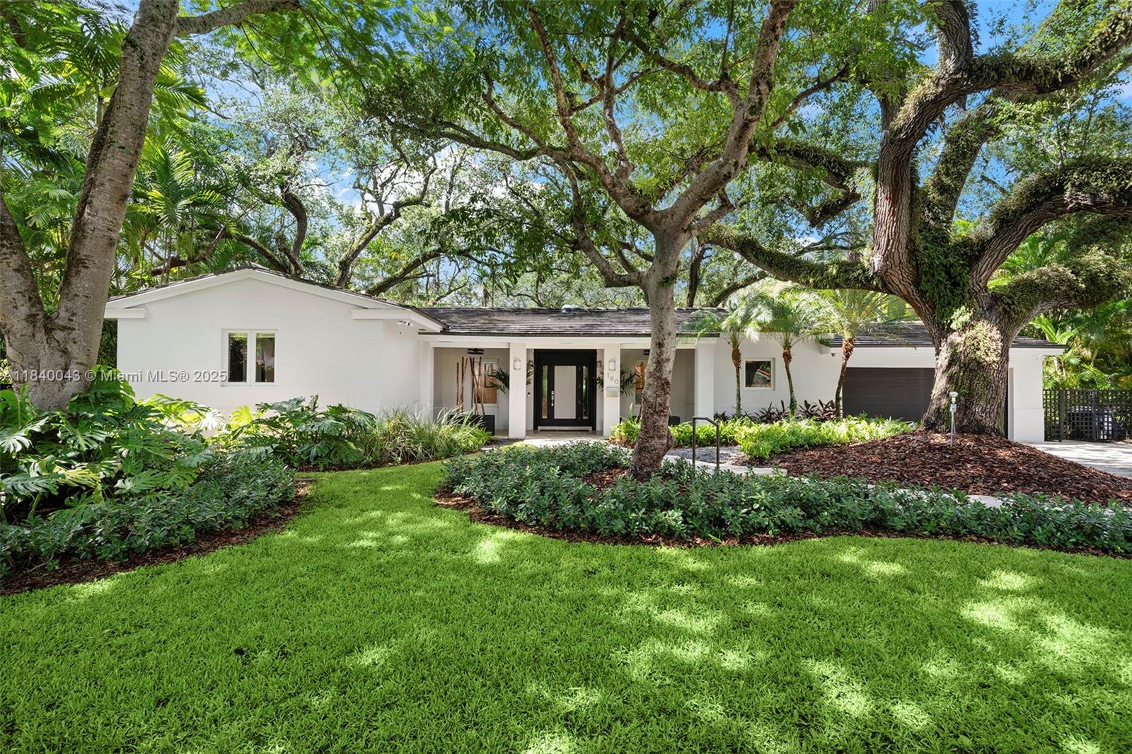 Situated at the top the ridge beneath a canopy of majestic oak trees, this completely updated Coral Gables home artfully blends sophistication with casual Miami living. This 3 bedrooms and 2½ baths showcasing travertine marble and hardwood floors, high ceilings, and impact-resistant windows and doors that flood every room with natural light. The magazine-inspired kitchen boasts quartz countertops, a bright breakfast nook and custom cabinetry, while the adjacent stone-paver terrace and  pool offer the perfect setting for indoor-outdoor entertaining. Additional highlights include a separate laundry room, spacious two-car garage, lush private landscaping and mature oaks framing an idyllic retreat in the heart of Coral Gables.