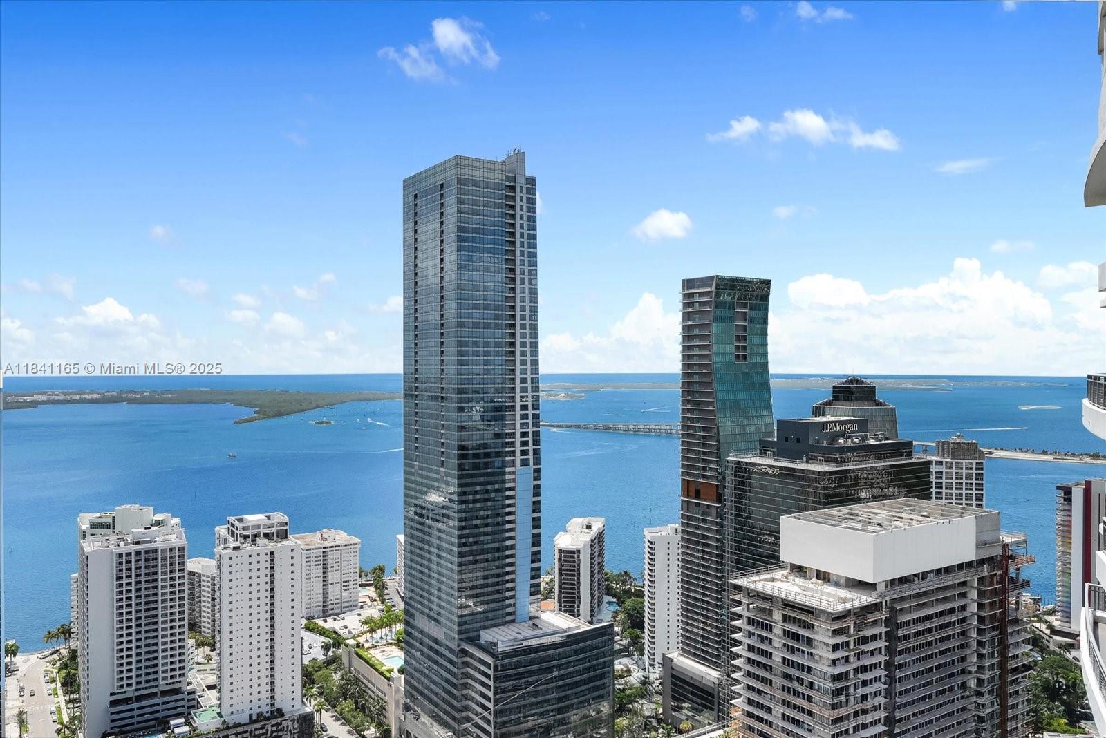 Live in the skies in this bright, airy, and spacious two-story loft featuring mesmerizing views of Biscayne Bay. The main level offers open living and dining areas, ideal for entertaining, along with a convenient half bath. Upstairs, two comfortable bedrooms and two full bathrooms provide privacy and relaxation. Enjoy dramatic ceiling heights, abundant natural light, and thoughtful separation between social and sleeping areas. The building offers great amenities including a pool, gym, games room, and social/party room. However, this exclusive unit enjoys access to a private roof-top sky deck who only floors 40 and up can access. A rare opportunity to own a beautifully designed loft-style condo with panoramic bay views in a full-service building.