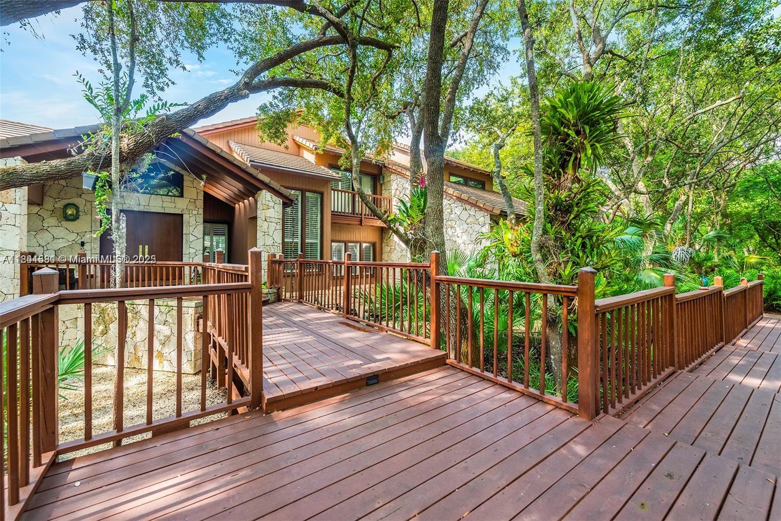 Set on a lush, oak-laden half-acre in Palmetto Bay, this fully furnished 4-bed, 2.5-bath retreat offers a rare blend of privacy, tranquility, and modern comfort. Gated entry leads to a bright, energy-efficient home with impact windows/doors and a spa-style primary bath featuring a Kohler Japanese soaking tub and TOTO bidet. Gourmet kitchen with high-end appliances and reverse osmosis system. Enjoy soaring ceilings, abundant natural light, and smart layout w/ multiple work-from-home spaces. Outside, your private resort awaits: saltwater pool, Jacuzzi, & spacious patio under a 2-story screened enclosure—ideal for year-round enjoyment.  Minutes from top schools, parks, and Miami hotspots. Rm for 4 vehicles. Relaxed, refined, move-in ready.  Owner prefers to rent furnished See Broker Comments,