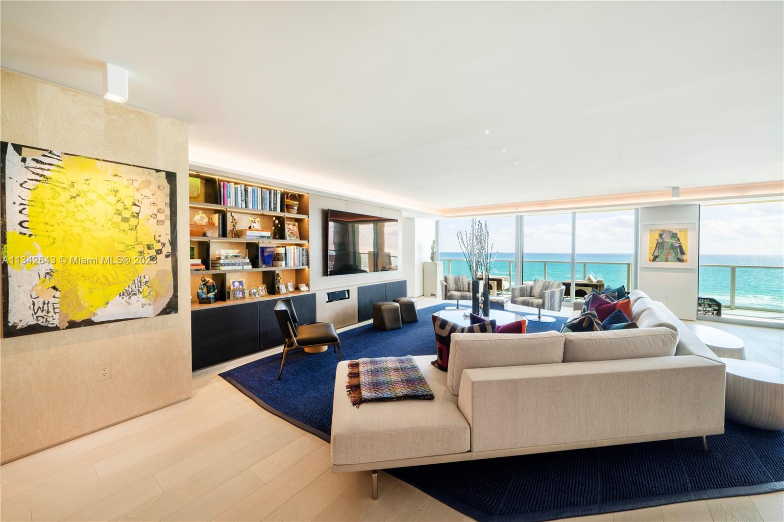 Living room with extensive built-ins & water views.