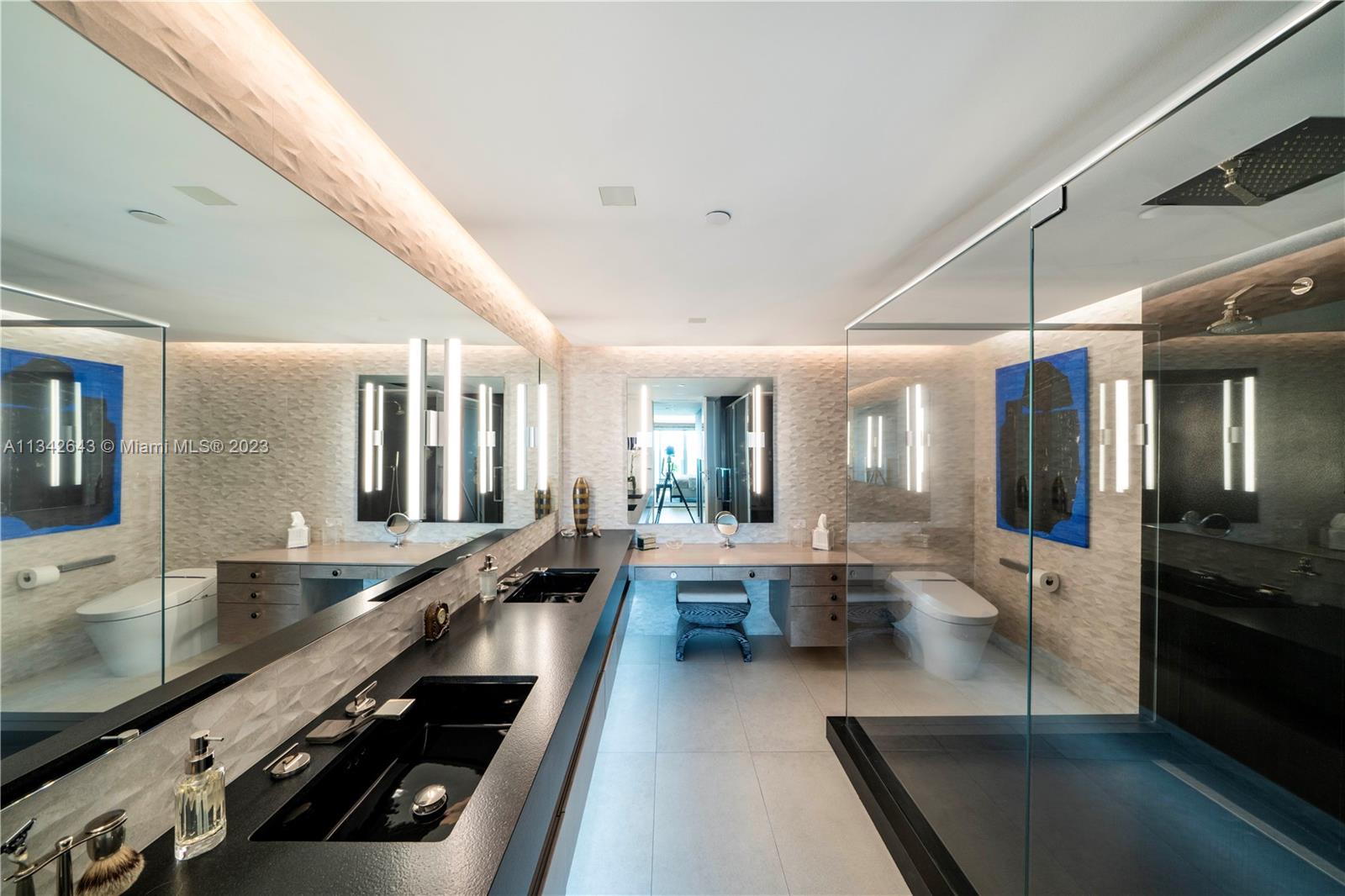 Primary bath with custom lighted mirrors, dual vanities, & shower with dual shower heads!