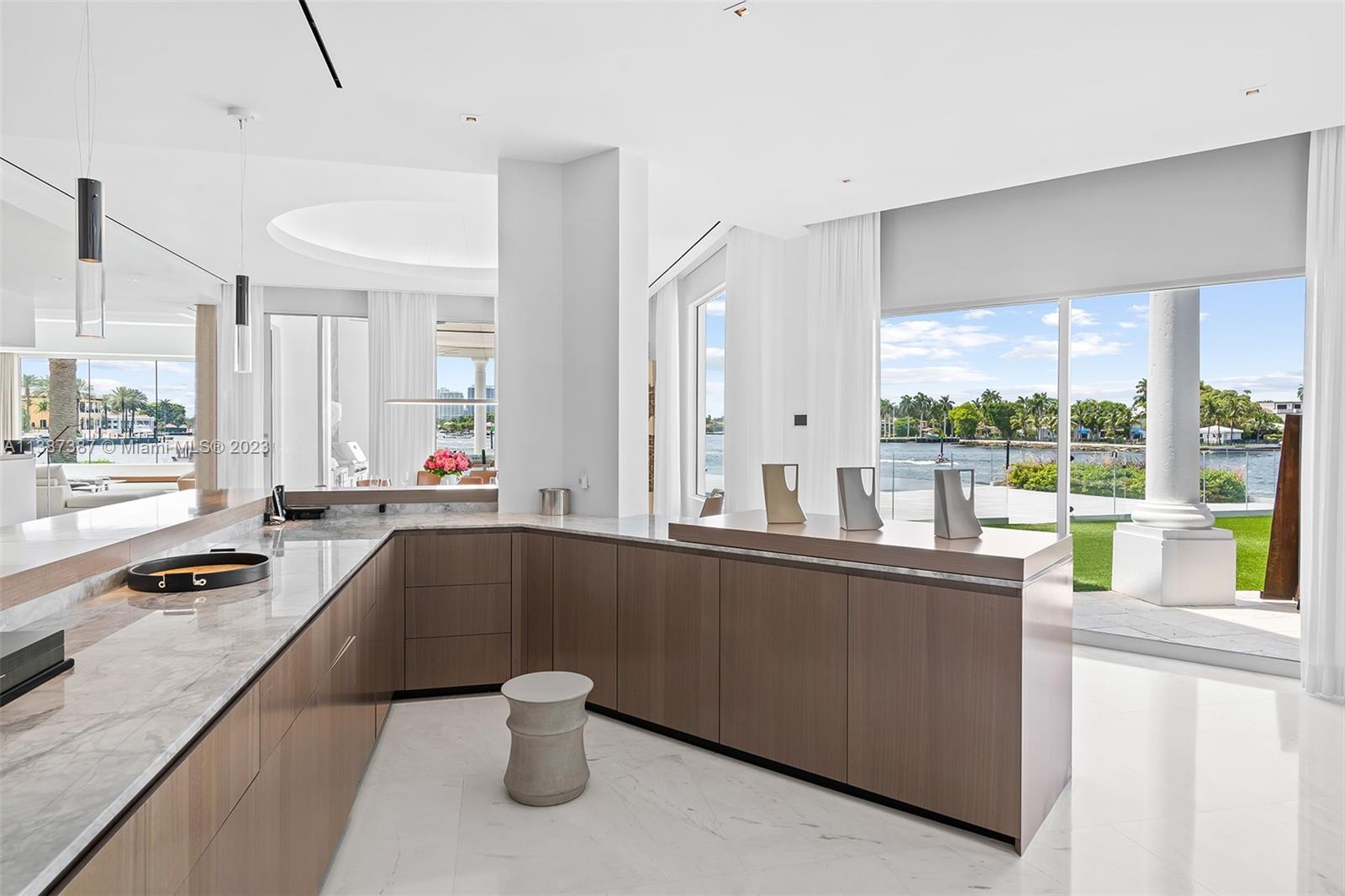 View of the Bar.  Each cabinet  has lighted pullout drawers for storage.  There is also a wet bar, ice-maker, 2 wine coolers and 2 full size dishwashers.  Plenty of storage for glasses and liquor.