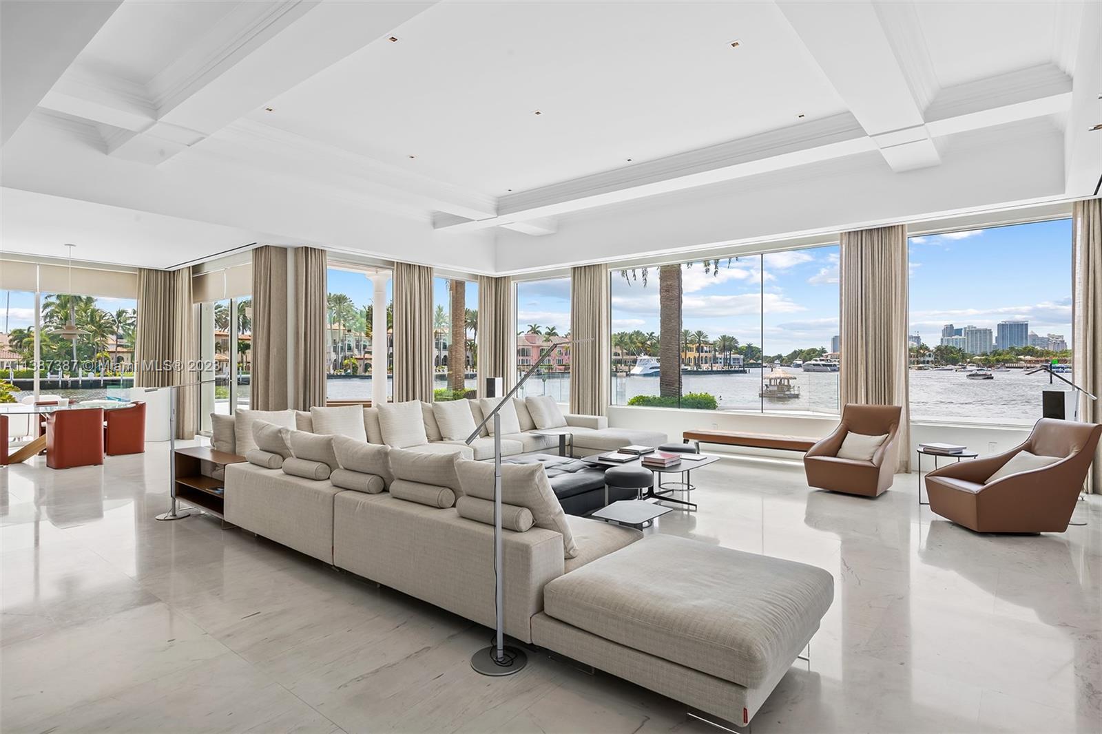 Family Room with West Facing Views.  Opaque Electric Shades that can be lowered in the afternoon still provide you with your view but block the intensity of our beautiful Florida Sun.  Notice, casual dining area to the left.