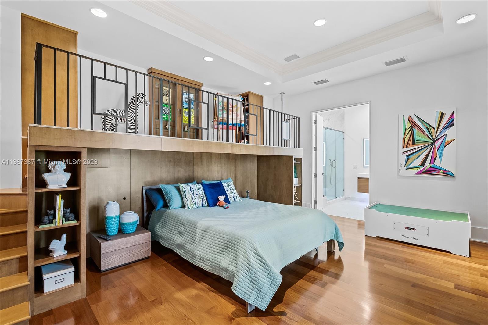 Secondary Bedroom currently setup for Child with play area above bed.  This room also has a private bathroom and walk in closet.