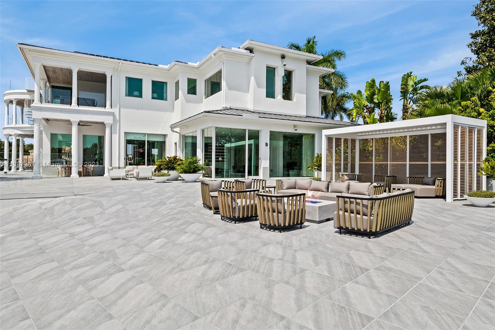 View of outdoor seating and firepit from the west.