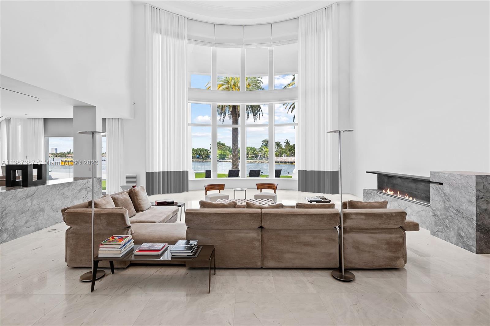 Formal Living room as you enter the house.  North views capture your eye as you enter the front door.  Large Bar is on your left as you enter and leads into the kitchen, dining and causal living rooms with west facing views.  On your left is an alcohol powered fireplace.