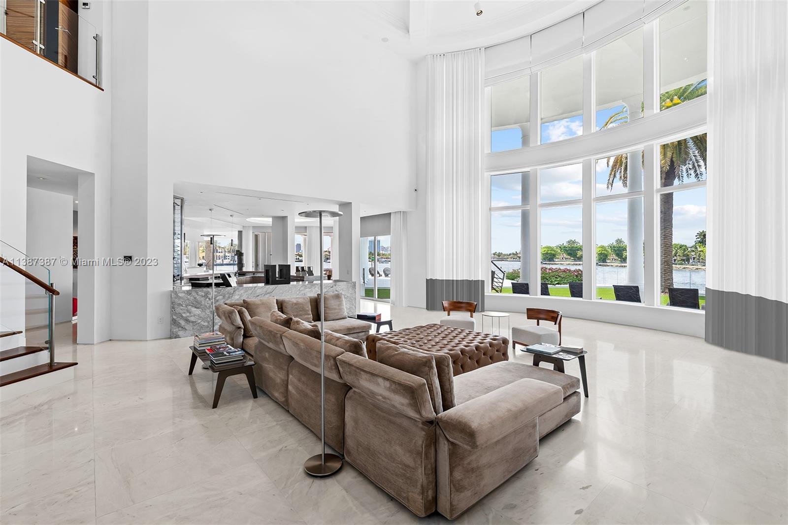 Formal Living room view from the North wing.  North views capture your eye as you enter the front door.  Large Bar is on your left as you enter and leads into the kitchen, dining and causal living rooms with west facing views.