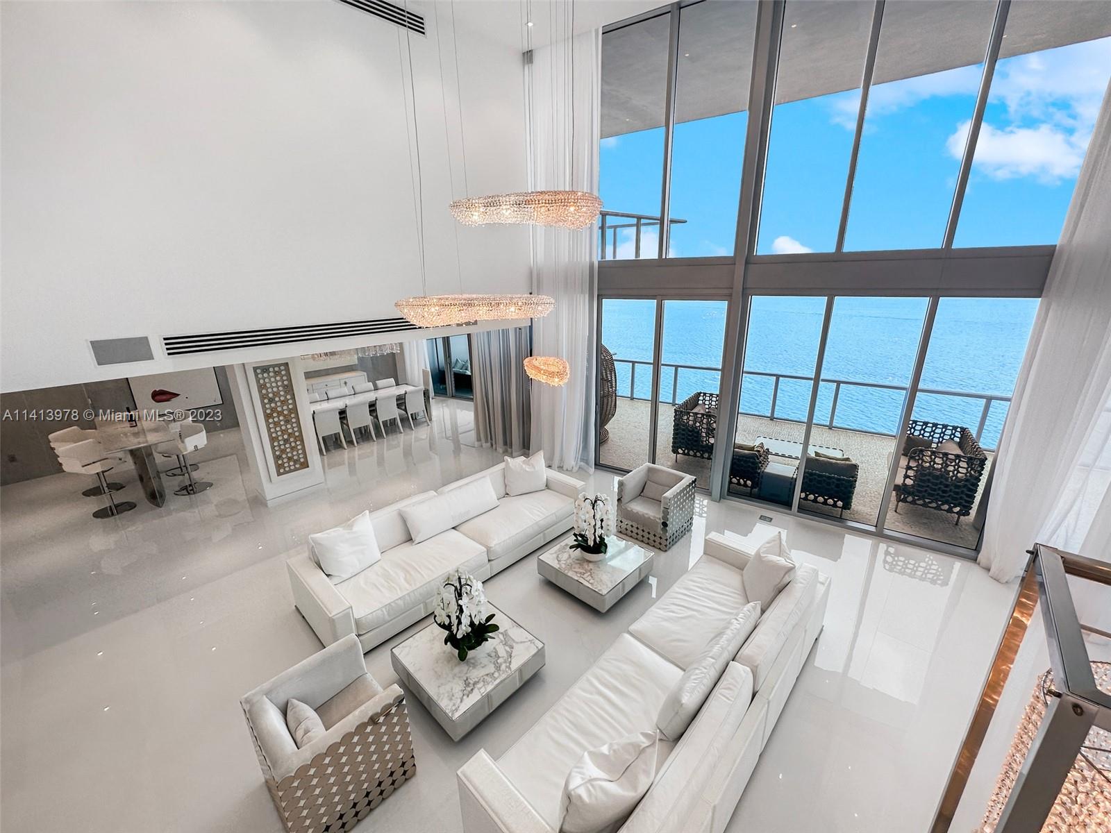 Over 1.5 M in Renovations & Italian Furniture this Two-Story SE Corner PH Boasts Panoramic Ocean & Miami Skyline  Breathtaking Views, 5 Bed/ 5.5 Bath, Total 6157 sq ft (4,490 sq ft interior & 1667 sq ft Expansive Terraces )21-ft Ceilings in Grand Living Area, Temperature controlled 120 Bottles Designed Glass Wine Vault, Complemented by Marble Wine Testing Table next to Formal Dining Area, Modern  Floating Staircase, Elegance & Opulence prevail. Renovated with Meticulous Attention to Detail, this Residence features an Eat-in custom-made Kitchen, Premium Appliances flowing seamlessly into the Family area & TV room. Oversized wrapped-around Terraces. Recently Renovated  Luxury 5-star Amenities: Sunrise & Sunset pool,Full Menu Restaurant , Spa & Gym, Pool & Beach Service, Kids room, Consierge.