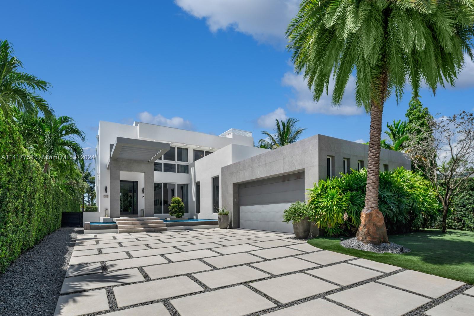 Step Inside With Me! Presenting a modern waterfront custom home in Miami Beach’s guard-gated Normandy Isle. This 5,400+ SF smart home boasts 5 beds and 5.5 baths. Interior highlights include formal & informal lounges, open kitchen with Dornbracht fixtures, tray ceilings, oak millwork, marble flooring & a proper cinema room. The water-facing primary features an office, spacious walk-in closet & an impressive marble bath, plus an oversized terrace. The spacious rooftop deck with stunning views offers a BBQ, dining area, and spa. Expect constant sun at the resort pool from its coveted Southern position. More to love: dock with boat lift, 60 FT of water,  2-car garage, privacy gate, solar panels & generator. Minutes from Normandy Shores Golf Club, 672 S Shore is ideal for boaters and golfers.