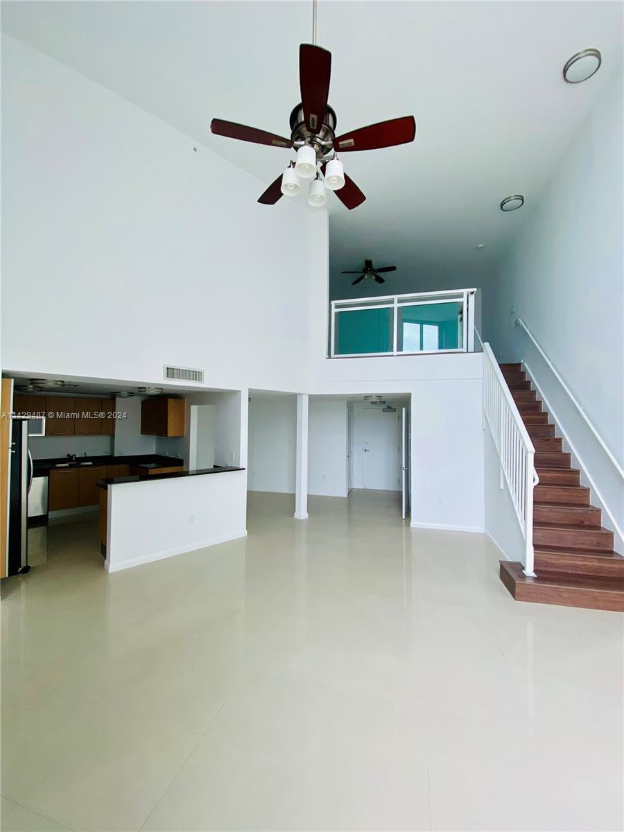 Spacious and bright living area featuring 20 ft ceilings