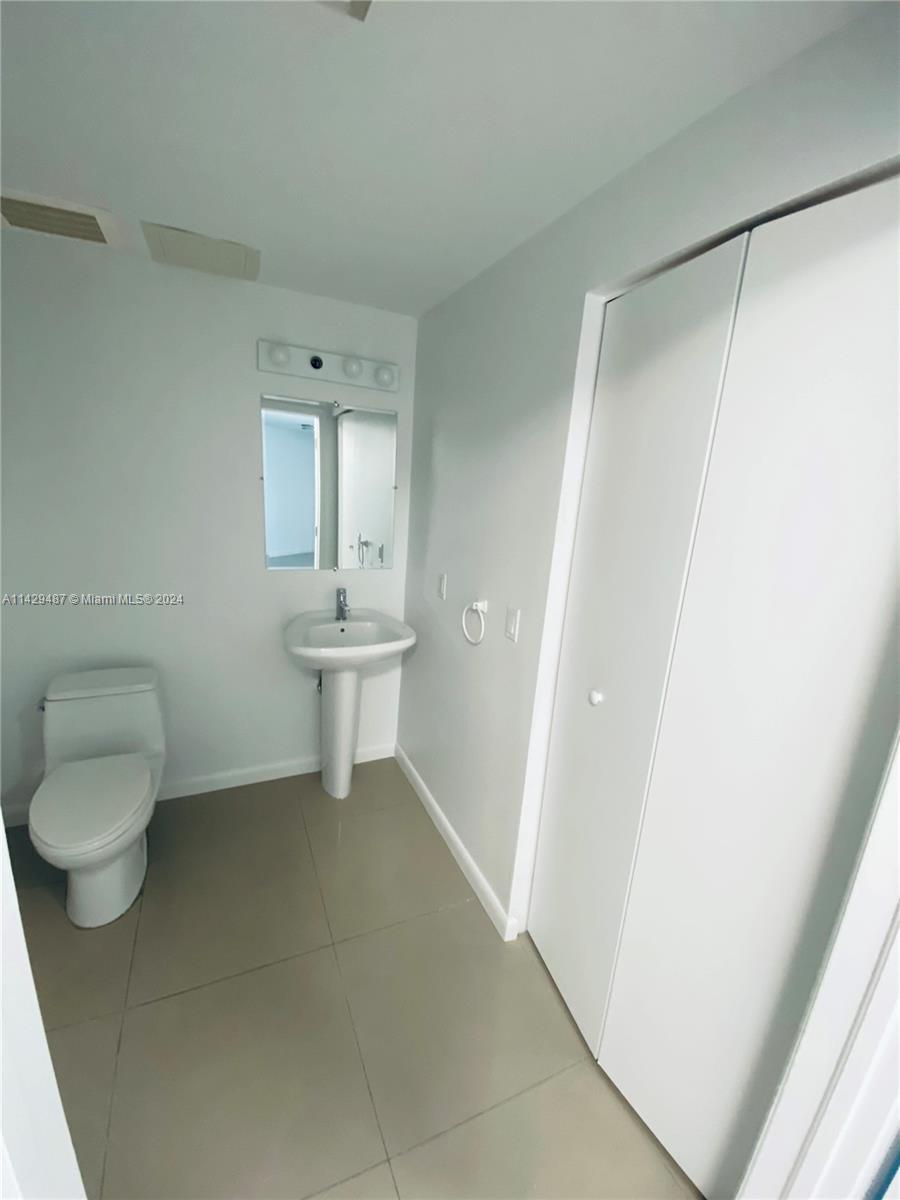 Half bathroom located on first floor with laundry