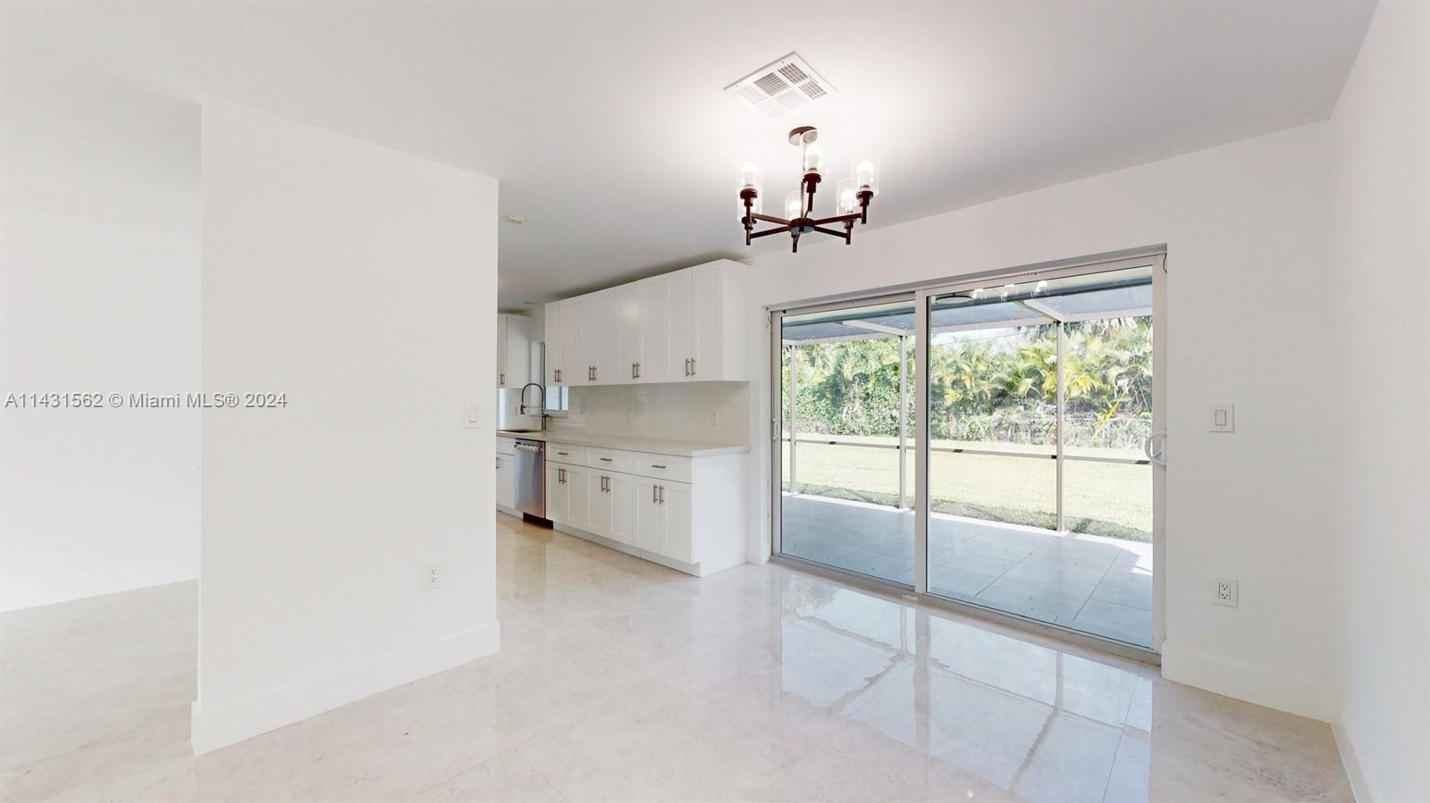 Now you can see deep backyard and the screened patio. And now you can see the  all white new kitchen cabinets.
