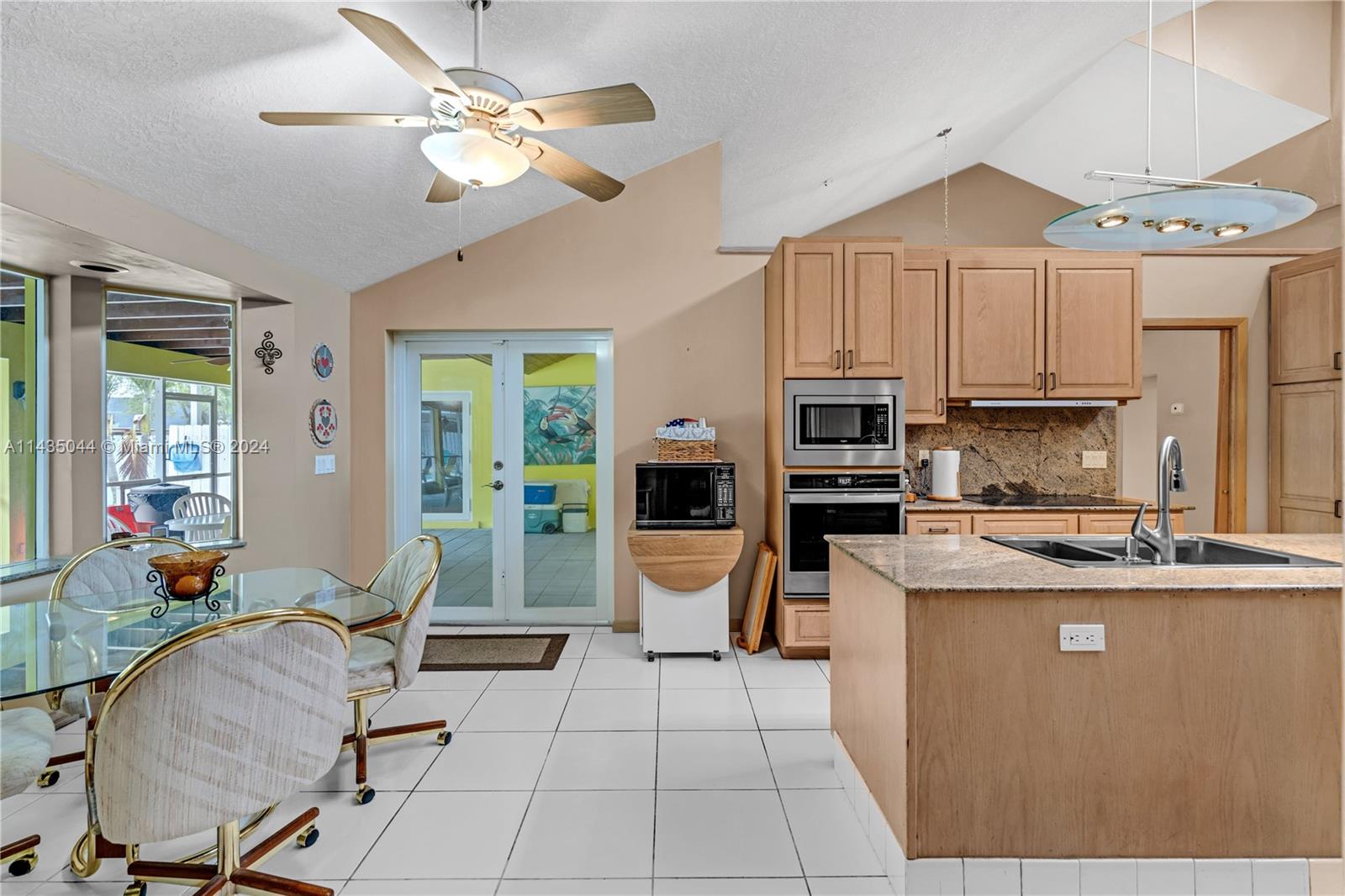 MAIN SUITE WHICH FLOWS INTO OFFICE/GYM WHICH OPENS ONTO COVERED SCREEN PATIO