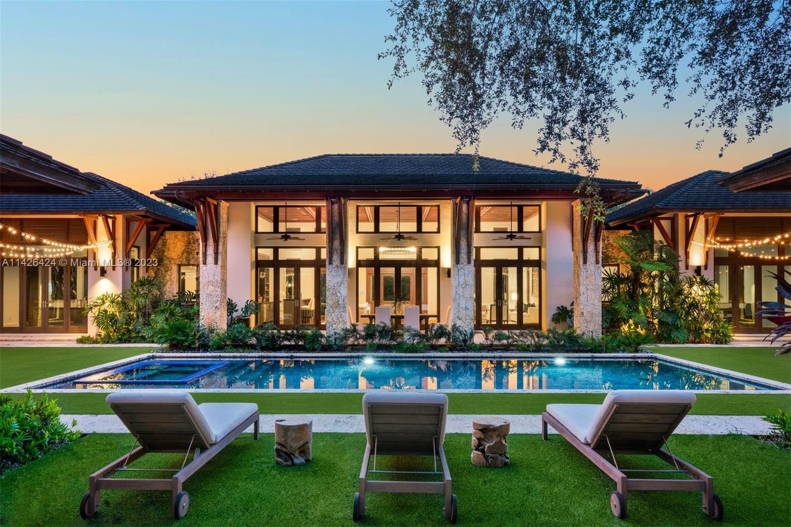 This magnificent 7,685 SF gated residence on 35,719 SF of lush, landscaped grounds was designed in 2015 by renowned architect Cesar Molina of CMA Design Studio. Capturing the allure of tropical Bali modern architecture, the use of elegant Cumaru wood and Native Oolite stone infuses the home with a natural and inviting ambiance. Every detail was meticulously attended to when customizing this retreat-style home, incorporating the finest designer finishes and modern conveniences. The home has 16-ft ceilings, 5 bedrooms, 6.5 bathrooms, a tremendous chef's kitchen with luxury appliances, and sprawling indoor/outdoor entertainment areas. Includes a Control4 security system, covered summer kitchen, saltwater pool, captivating water features, putting green, and a full-house generator.