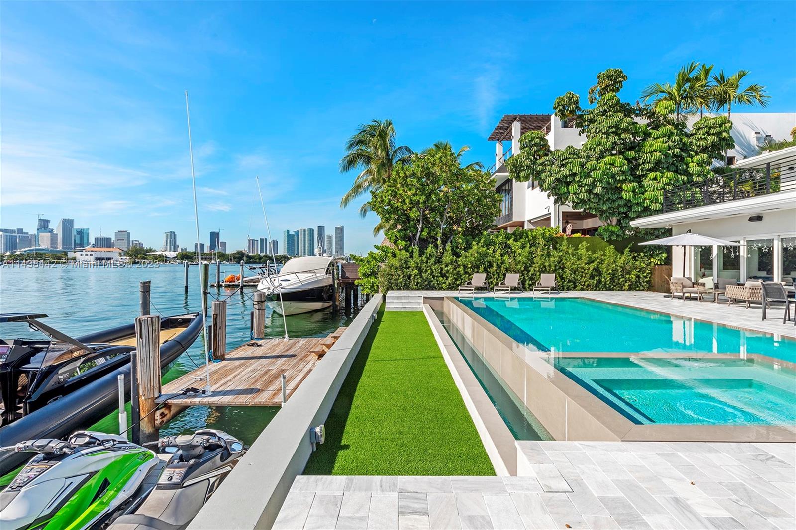 This stunning 2-story southern facing home offers unobstructed open Bay & downtown views, sitting on a 12,250 SF lot & ideal for boaters w/private dock, 70’ WF & direct bay access. Home is adorned w/tile & oak plank wood floors, oversized eat-in kitchen w/top-of-the-line Wolf appliances & marble countertops. Spacious open living area surrounded by walls of glass w/bar & sweeping bay views. Principal suite is an oasis w/beautiful spa bathroom, an oversized balcony w/views over the pool. Outdoor entertaining area with a summer kitchen, infinity pool, ample outdoor lounging areas. This property offers an exceptional Miami lifestyle, combining luxury, stunning views, elegance & outdoor living.