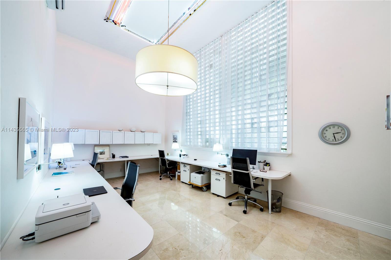 Office with soaring 20ft ceilings filled with natural light.