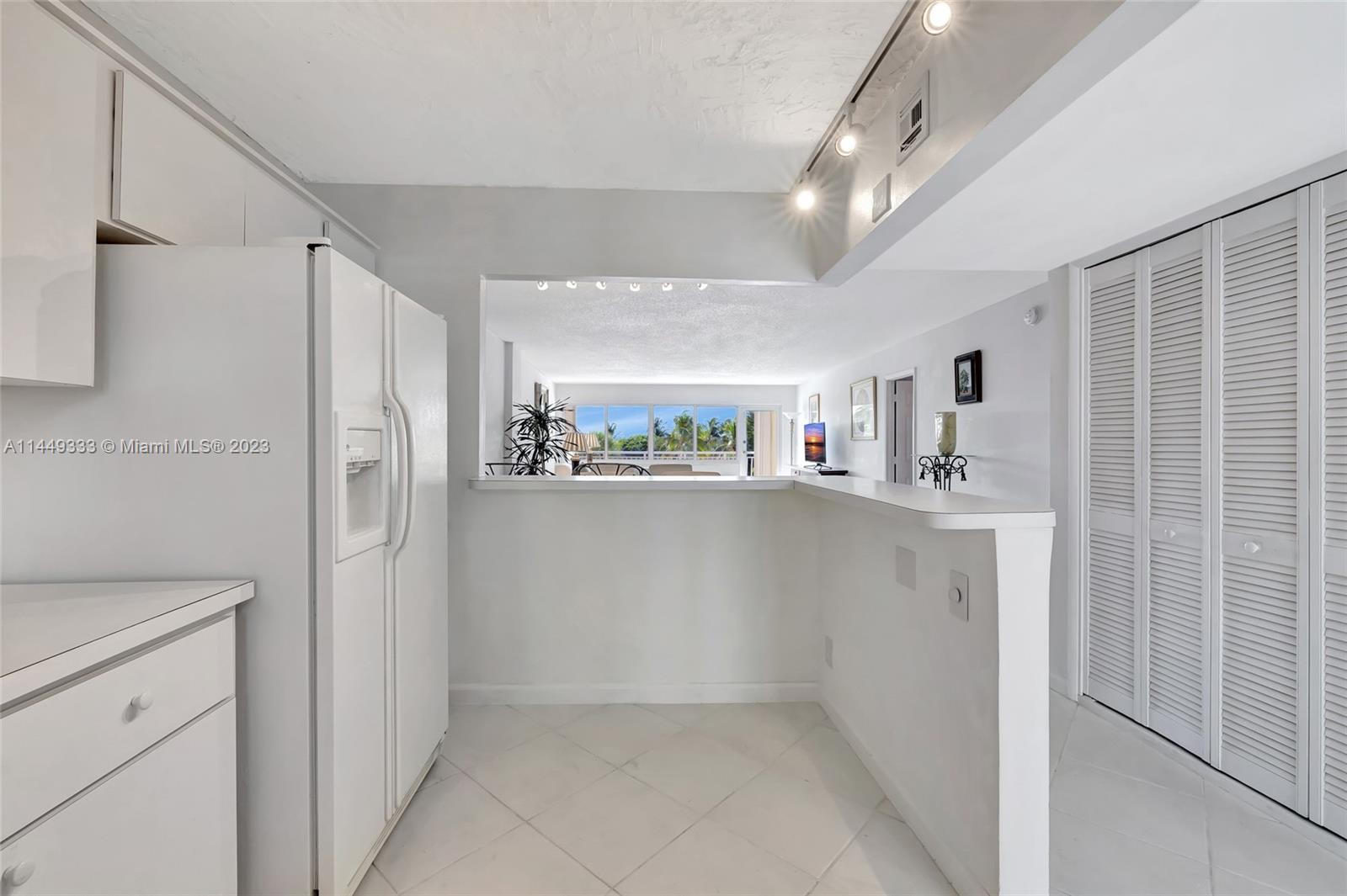 Kitchen, Living Room/Dining Room area and balcony with view of the pool and ocean