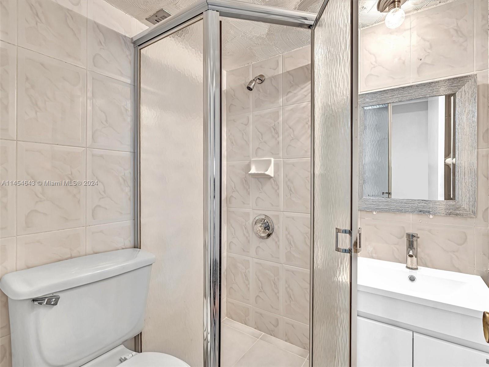 Primary bedroom, staged to show views to balcony and ocean