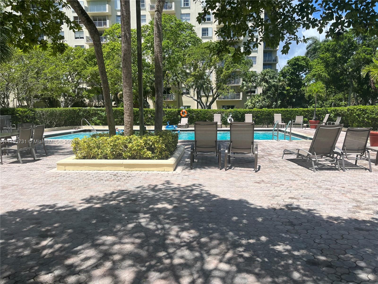 Pool decj with enough lounge chairs around the pool to sunbath or relax.