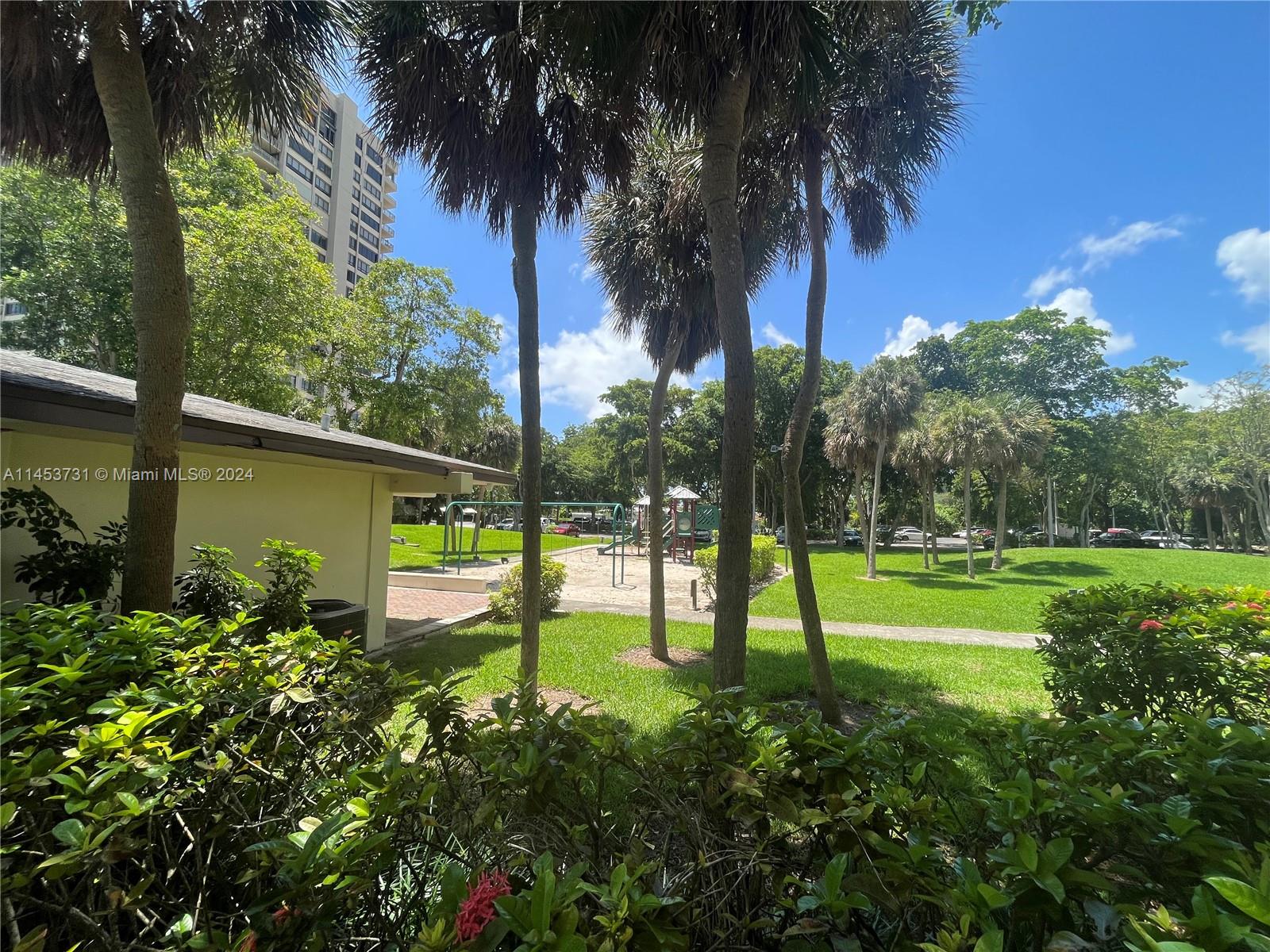 Children's area on a very nice garden with trees and grass.