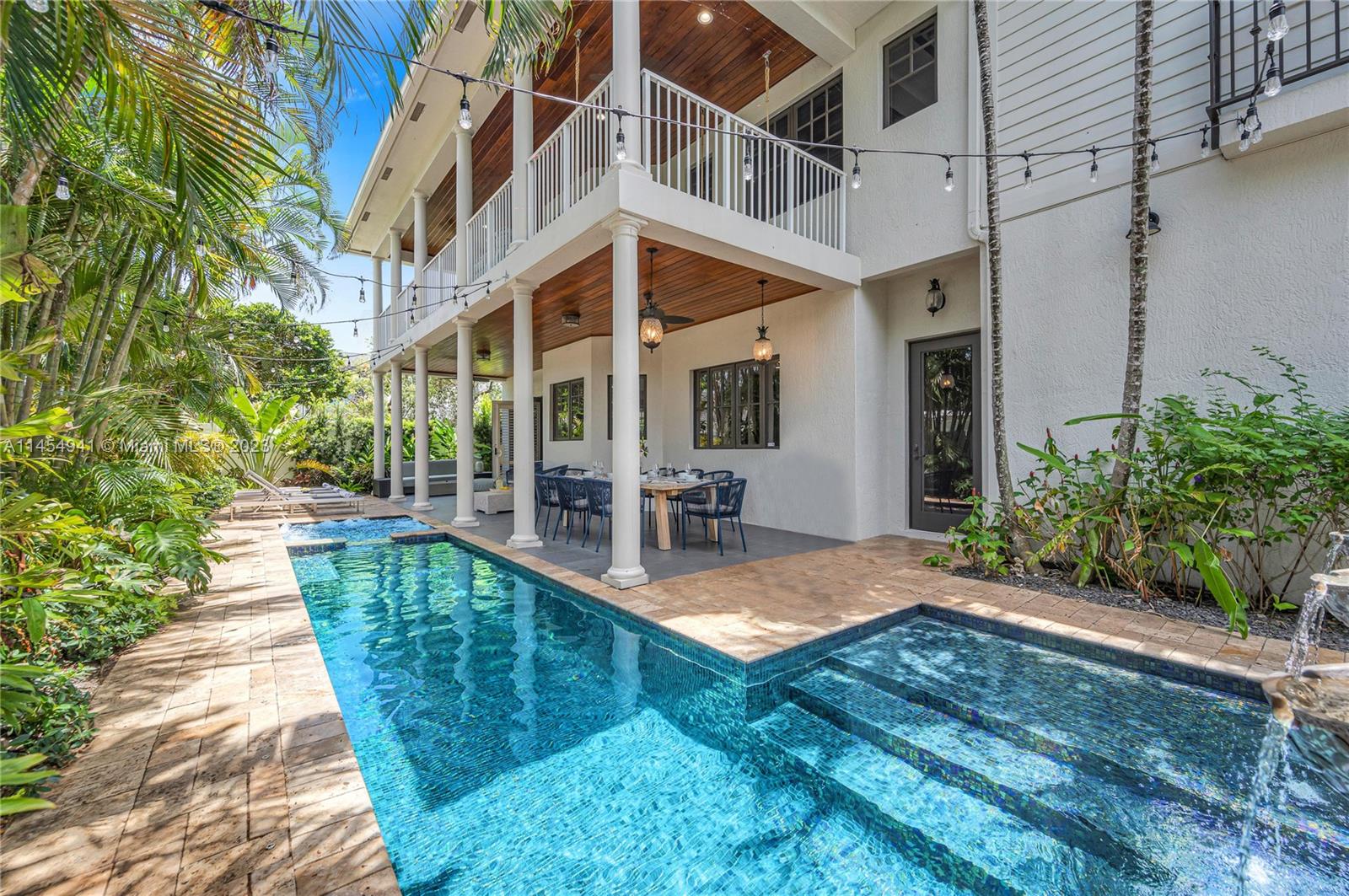 Beautiful heated pool and spa with glass tile and waterfall