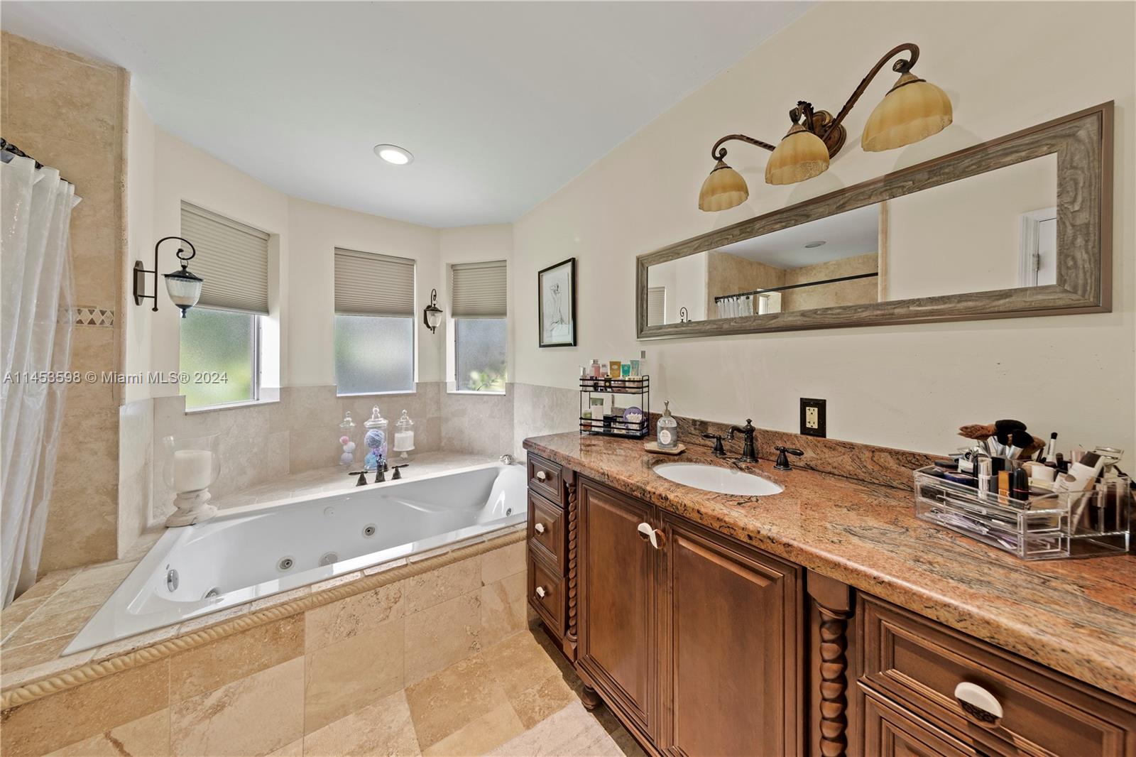 PRIMARY SUITE BATHROOM W/ ROMAN TUB AND SEPERATE SHOWER.