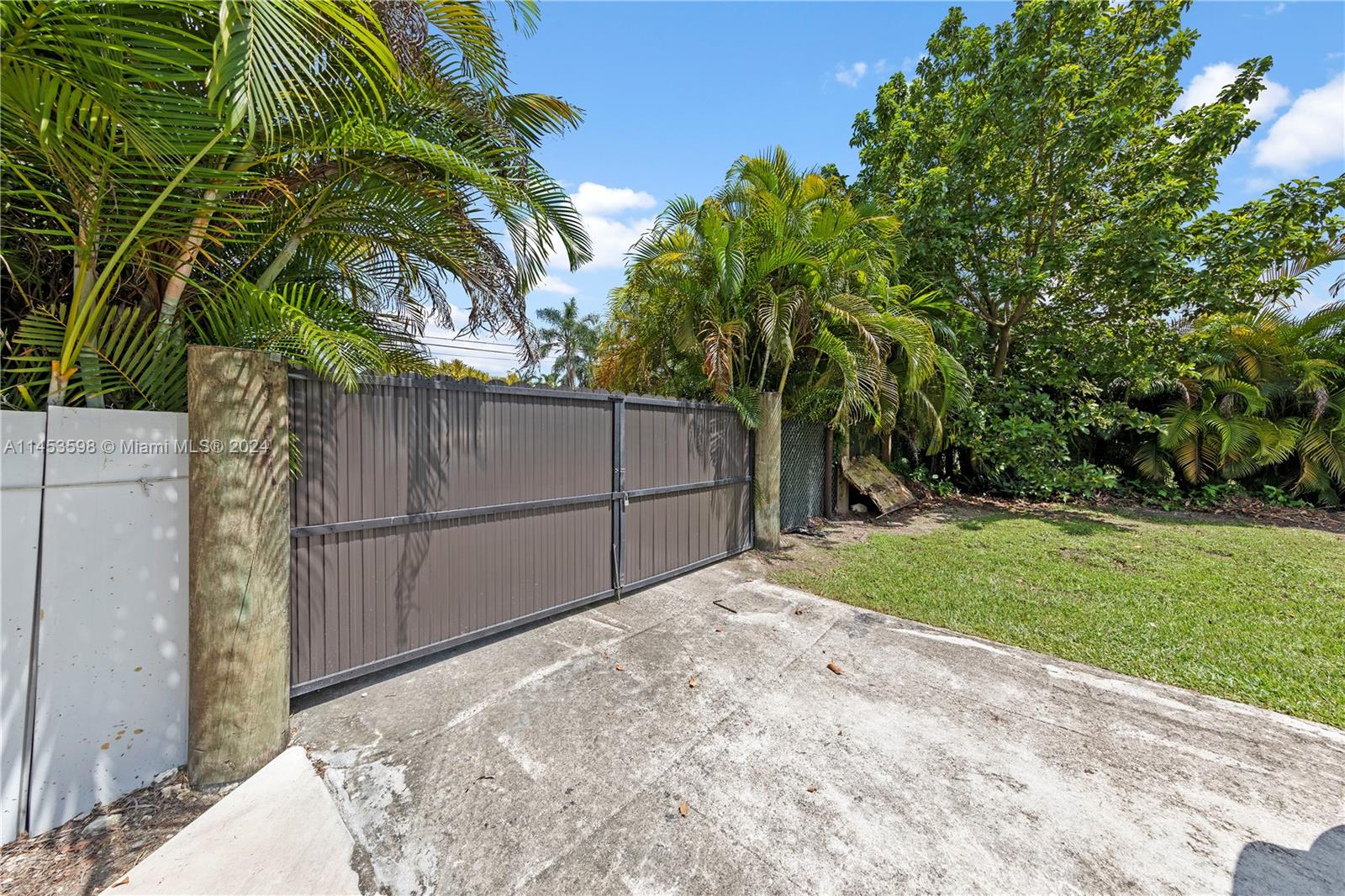 1 OF 3 ENTRANCES W/ CUSTOM GATES THIS GATE ACCESS THE WORKSHOP/ RV AND PARKING