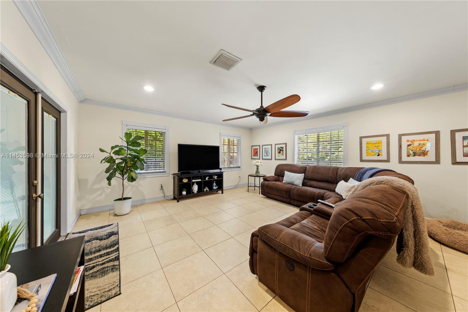 FAMILY ROOM W/ FRENCH DOORS TO COVERED SCREENED PATIO