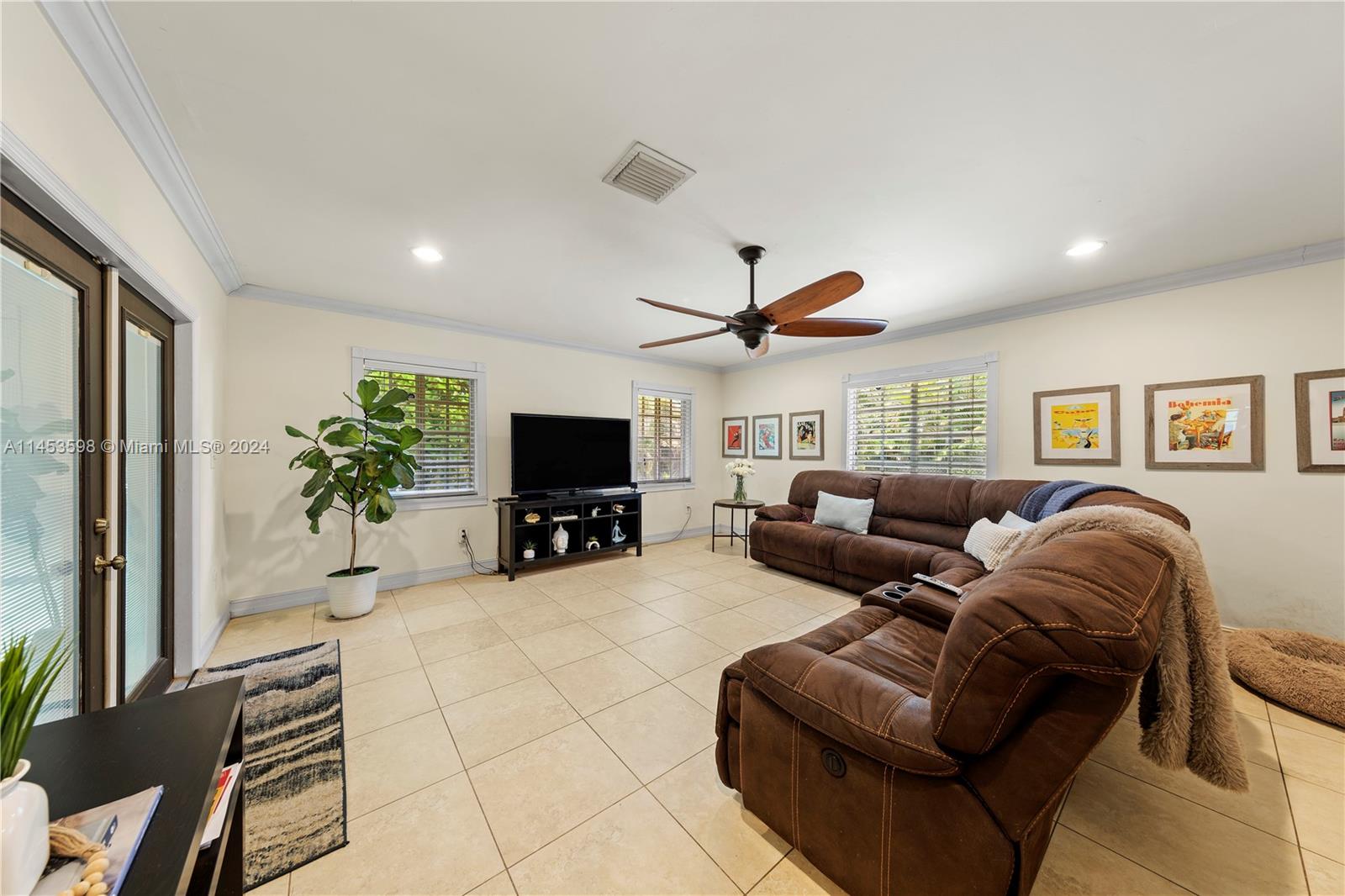 FAMILY ROOM W/ FRENCH DOORS TO COVERED SCREENED PATIO