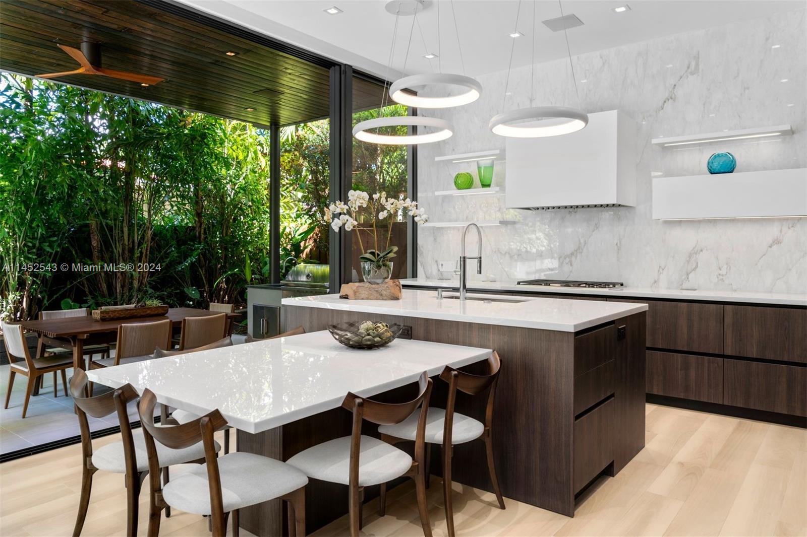 Beautiful kitchen with outdoor kitchen area and room to sit 6 comfortably. Top of the line Sub-zero and Wolf appliances.