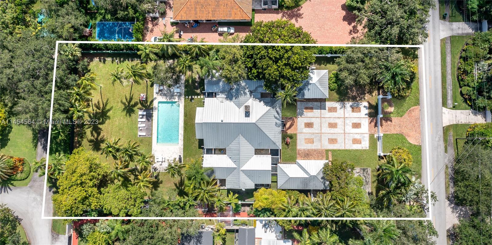 Key West style estate, situated on a sprawling 1-acre street to street lot in the desirable CORAL GABLES neighborhood. This 7,174 SF Total single-story home, 7 beds, 8.5 baths & 3-car garage, WITH HEIGHT TO FIT LIFT UP TO 6 CARS, which is any car collector's dream. Its prime location near top-rated schools, Gulliver, Carrollton, Ransom, and more. This Multi-Generational home is perfect for In-laws/professional kids returning home, with 3 detached rooms: office w onsite bath, 2 Beds w a sharing bath. The kitchen is complete w top-of-the-line appliances. The primary suite offers a spa-like bath & outside shower. Each of the 4 beds have en-suite baths. The outdoor area is an entertainer's paradise, featuring a covered terrace, a pickleball court, and a stunning pool w a detached cabana bath.