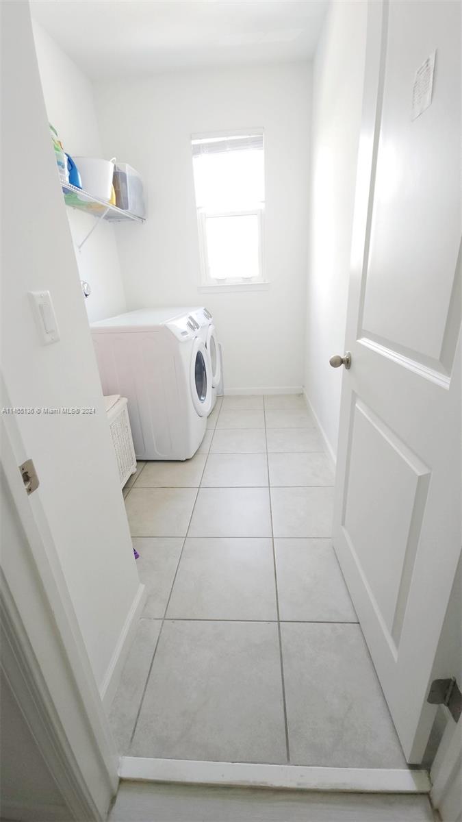  laundry room with storage adds to the convenience of daily living.