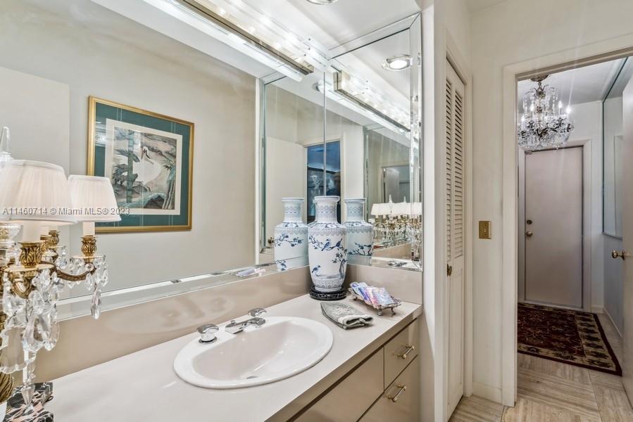 The 5th Bathroom  is just off the Family room & Living room and the door opens to the Pool Patio and it functions as both the powder room and as the Cabana Bath.