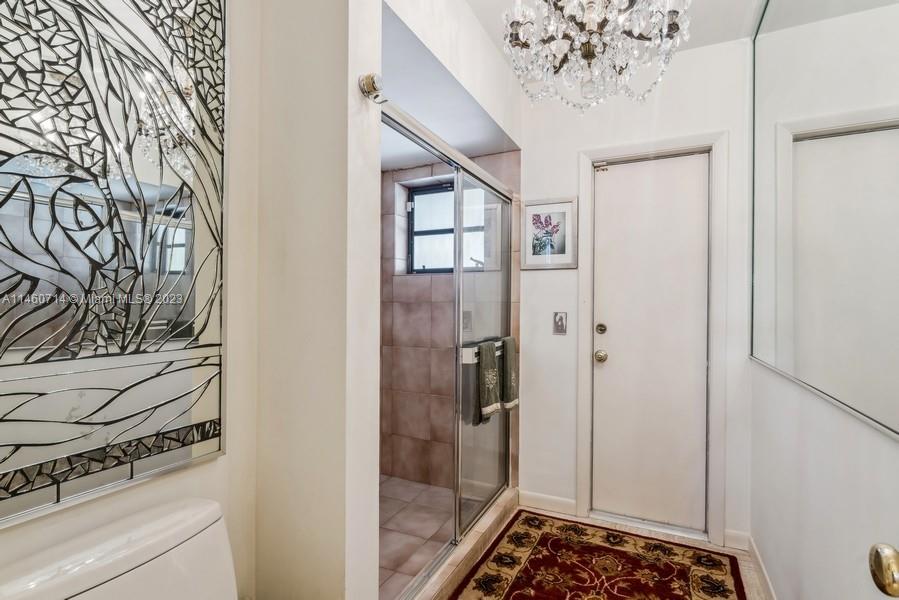 The Cabana/Powder room bath. The door leads out to the screened Pool-Patio & the Lake!