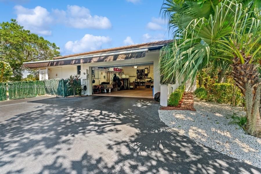 Notice the long driveway to the 2 Car Garage that has an electric awning on the West side of the house.