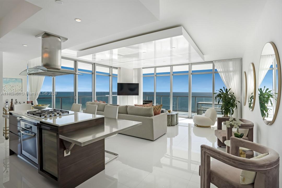 Recently renovated rarely available high floor direct ocean trophy condo at the Caribbean Residences in Mid Beach. Floor to ceiling windows and unobstructed ocean views abound from every room. This contemporary home in the sky features a 100 foot long 900 sf wraparound balcony providing an extraordinary crystal blue beachfront paradise. Amenities include 24 hour concierge, valet, security, full service beach, pool, spa, gym, media room, cigar humidor, wine vault