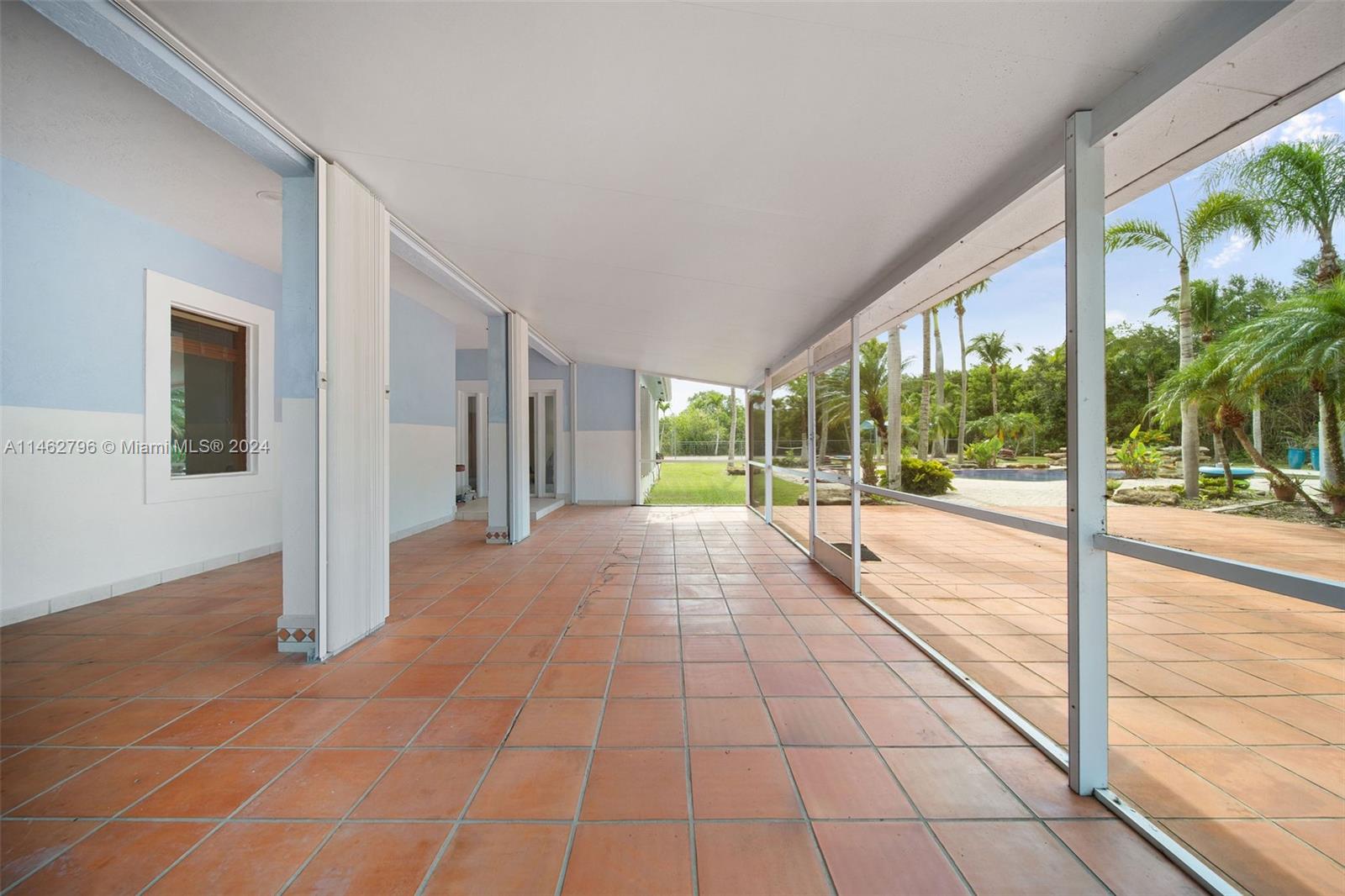 Screened back patio overlooking the gorgeous pool.