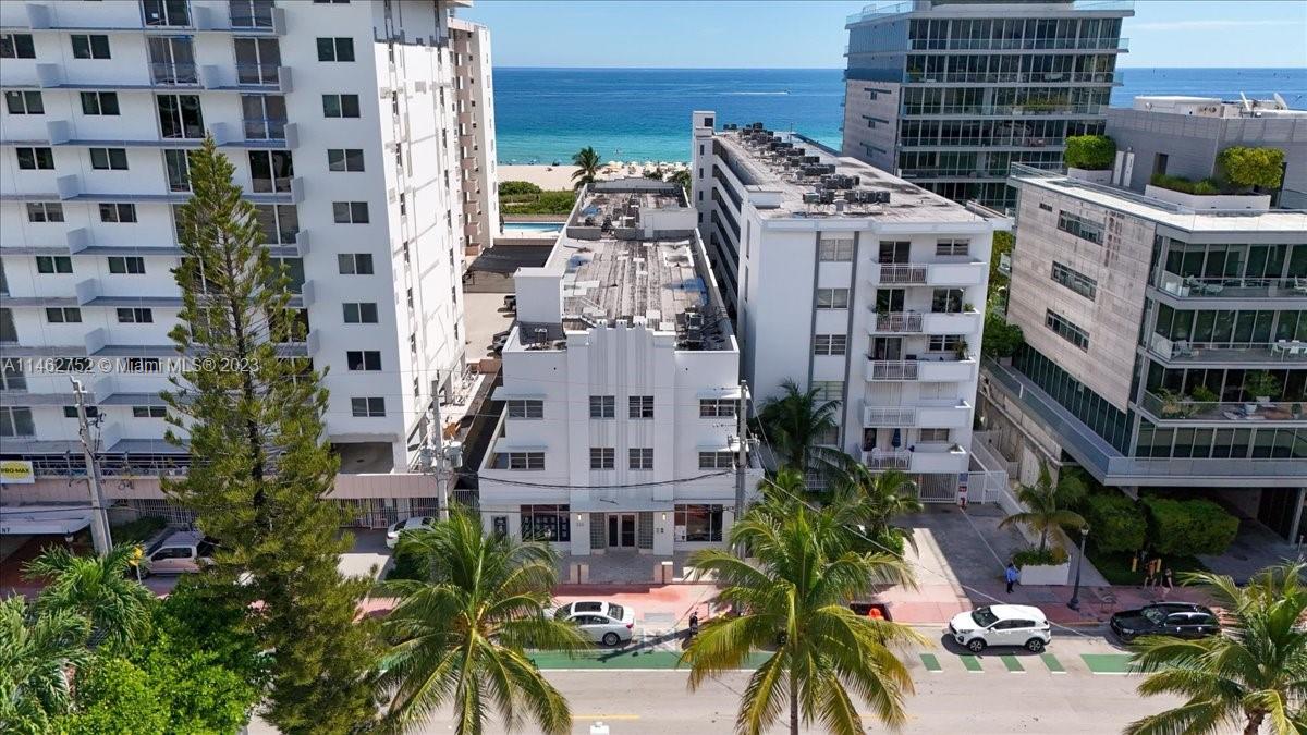 Aerial view of the building. White 3 story building.