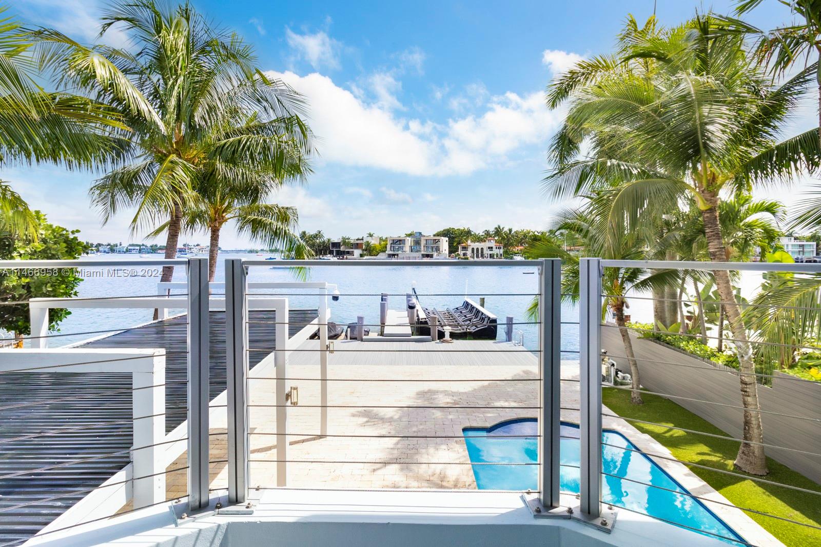 This spectacular waterfront home has been totally renovated with a construction upgrade of a new entrance and third floor railings in 2019. All the bedrooms are in suites and facing the open bay. 5 bed 5 1/2 bath with rooftop terraces. 36 x 24 CARIBBEAN BLUE marble & wood floors throughout. Beautiful kitchen with top of the line appliances, granite counter tops, impact windows, storage room, sound system, brand new back-up generator installed in 2023, solar heated pool, new dock and new 50 linear foot seawall. New floating lift that holds up to 25, 000 lbs, and a floating dock for 2 jet ski. The Second and third floor of the house were built in 1989. With breathtaking views this beautiful property is ready for a new owner. Come enjoy the gorgeous view of the bay, and Miami.