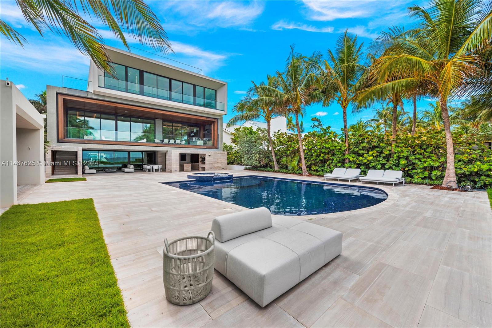 Modern tropical oasis nestled between swaying palm trees on the Atlantic Ocean in exclusive Golden Beach, Miami! Indulge on abundance of extravagant amenities and panoramic ocean views, with the beach as your backyard! The 12,000-SF mansion just underwent a million-dollar makeover and is staged by Artefacto’s sublime collection of furniture that blends with the beach vibes. Oceanfront living areas include a wet bar, gourmet kitchen, elegant dining rm, family rm, living room, huge terrace with summer kitchen. Dreamy primary suite has marble hers/his baths, walk-in closets. Ground floor entertainment space features a show-stopping, Shelby Cobra - courtesy of Prestige Imports. Amenities: rooftop, theater, guesthouse, 4 kitchens, elevator, patio, cabana. Furniture and car, avail separately.