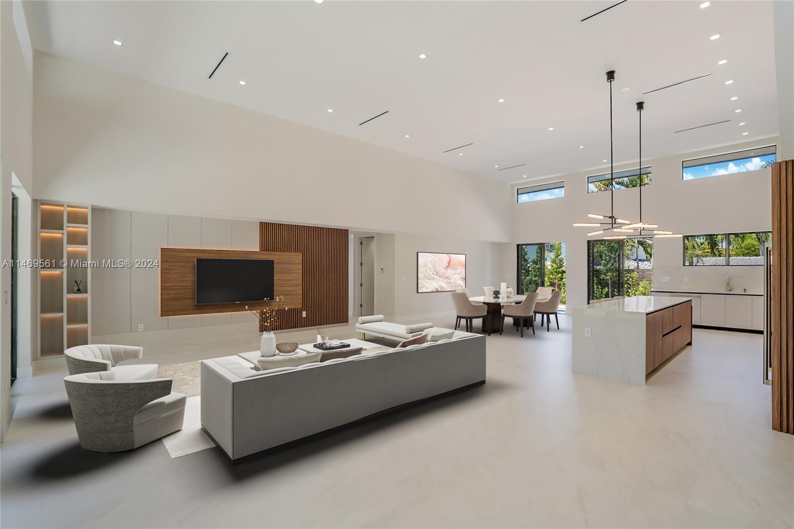 The primary suit bathroom features: Calacatta tile throughout, a frameless shower, a freestanding tub, custom-made stone dual sinks, custom-made cabinetry and a crystal pendant.