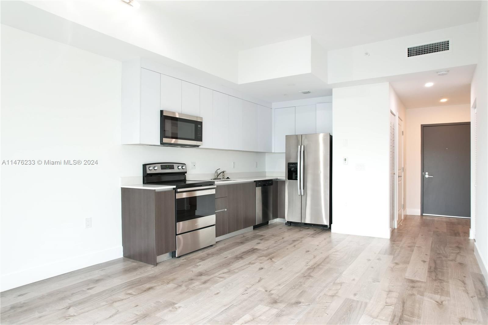 Modern Kitchens w/ side by side refrigerator and stainless steel appliances