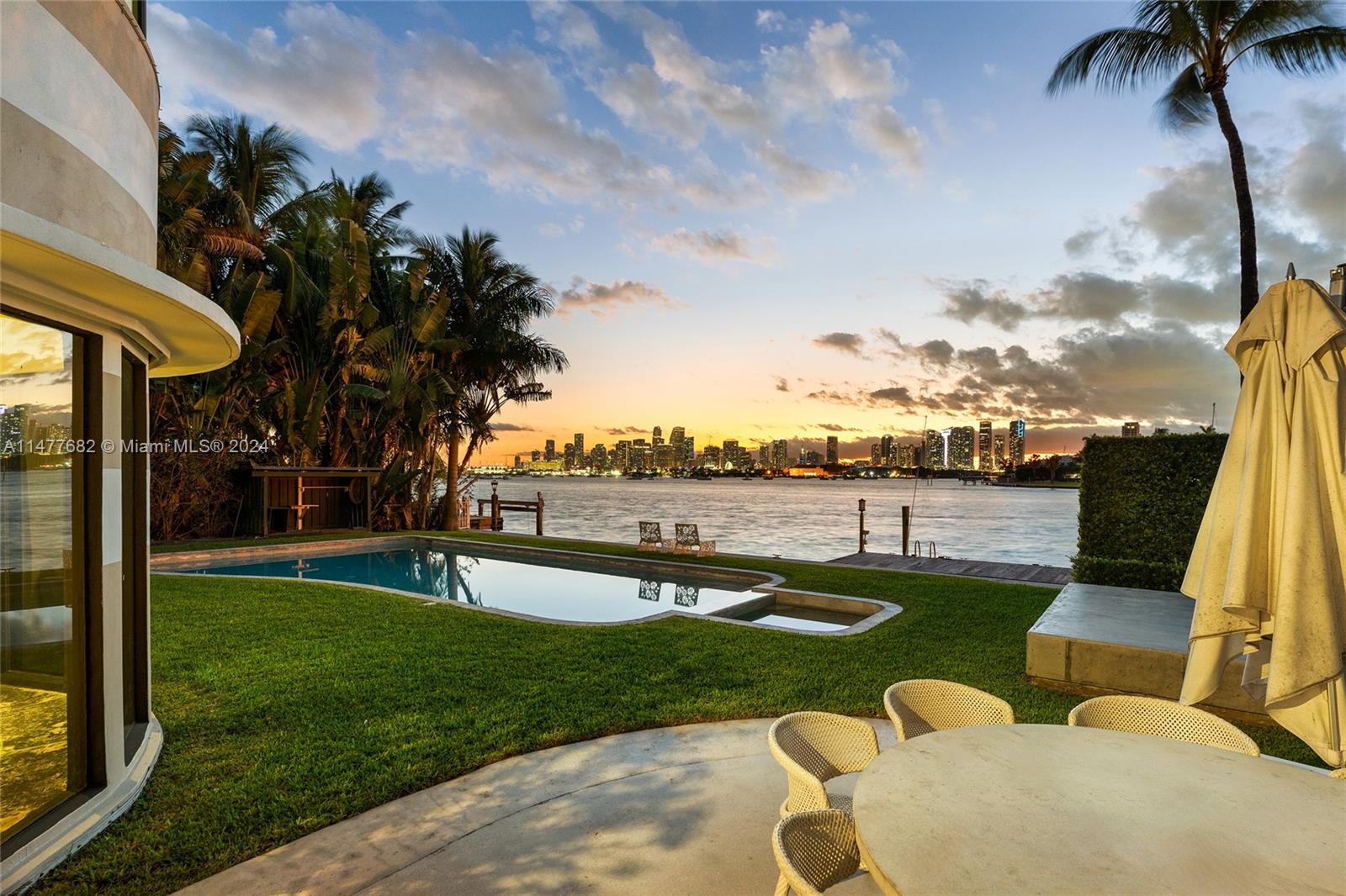 This charming 2-story Art Deco bayfront home sits on a 15,750 SF lot on the Venetian Islands & was designed by renowned architect L. Murray Dixon. An amazing opportunity to develop a beautiful new estate w/open Biscayne Bay & downtown sunset views or renovate the existing 4BR/5+1 BA home. Gated entry, original stone floors, open living room w/fireplace & direct bay views & separate dining area, plus a family room. Includes a detached 1BR/1BA guest house w/living/dining area. 2nd floor bay-facing principal suite w/large windows & views over the open bay & downtown, plus dual principal bathrooms & large walk-in closet. 2 other upstairs bedrooms w/en-suite bathrooms & private terraces. Large pool, lounge areas, summer kitchen, 90’ WF, private dock & ocean access. Amazing central location.